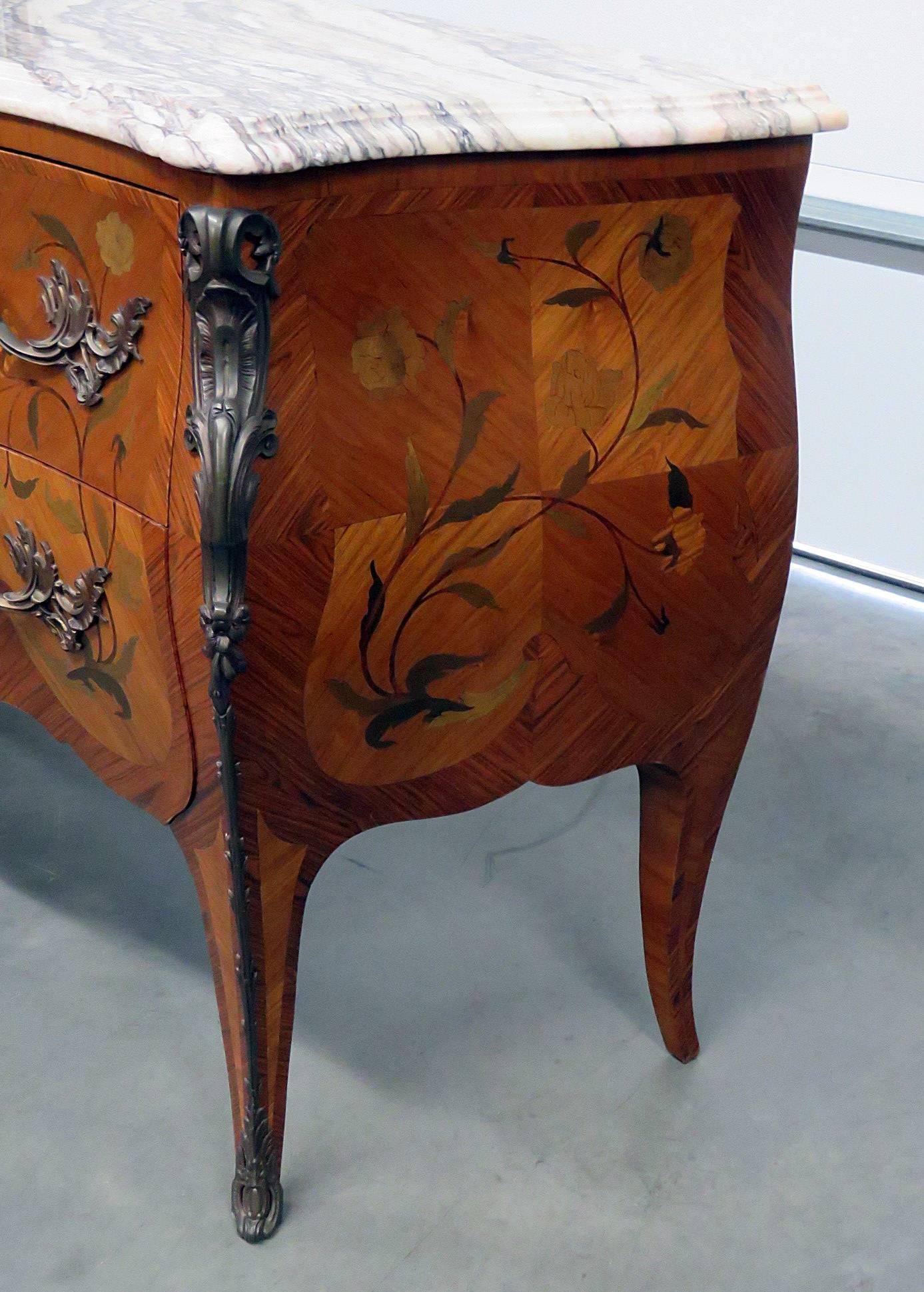 Inlaid marble-top commode with two drawers and bronze accents.