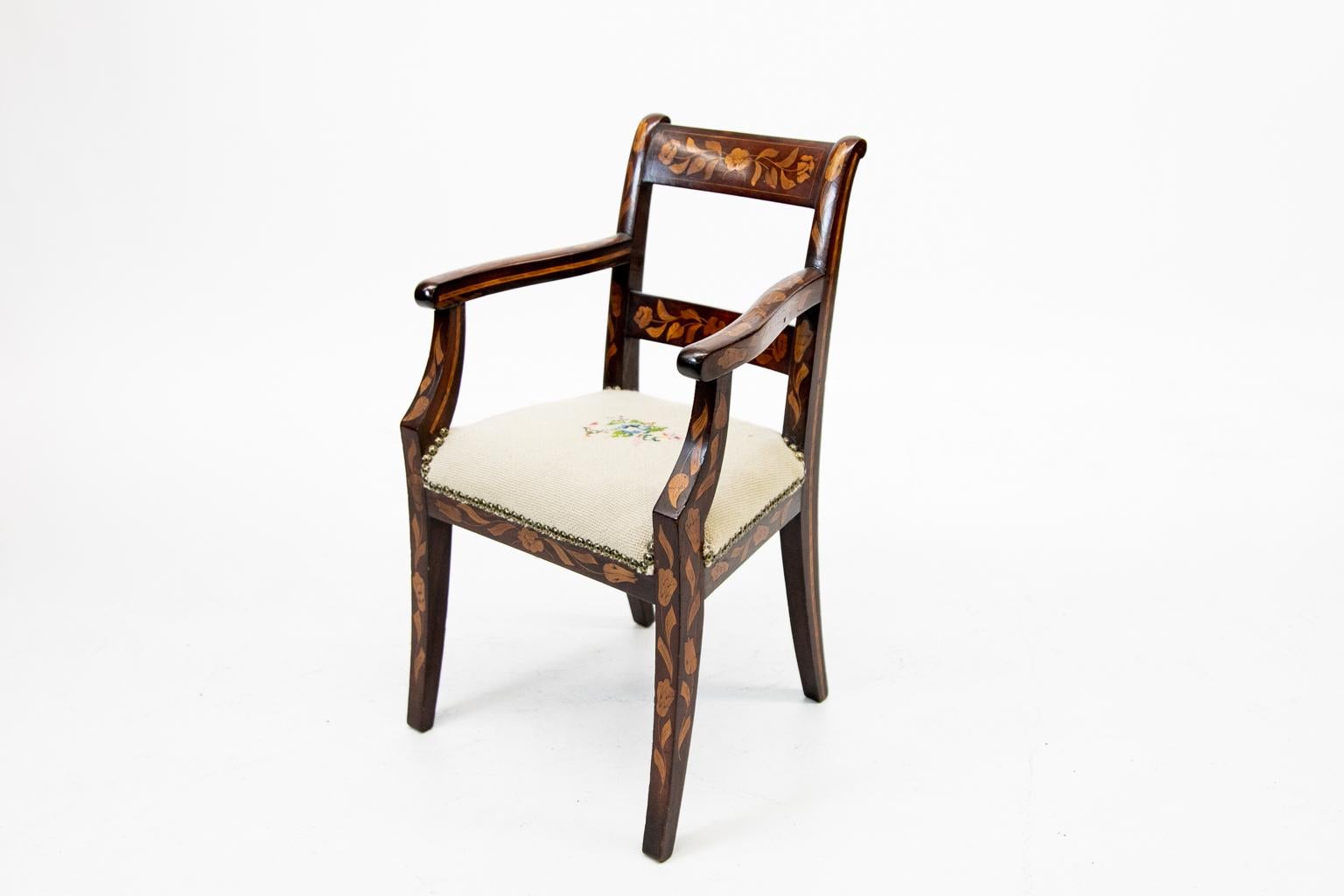 Inlaid marquetry child's armchair, with floral inlay throughout, needlepoint seat.
