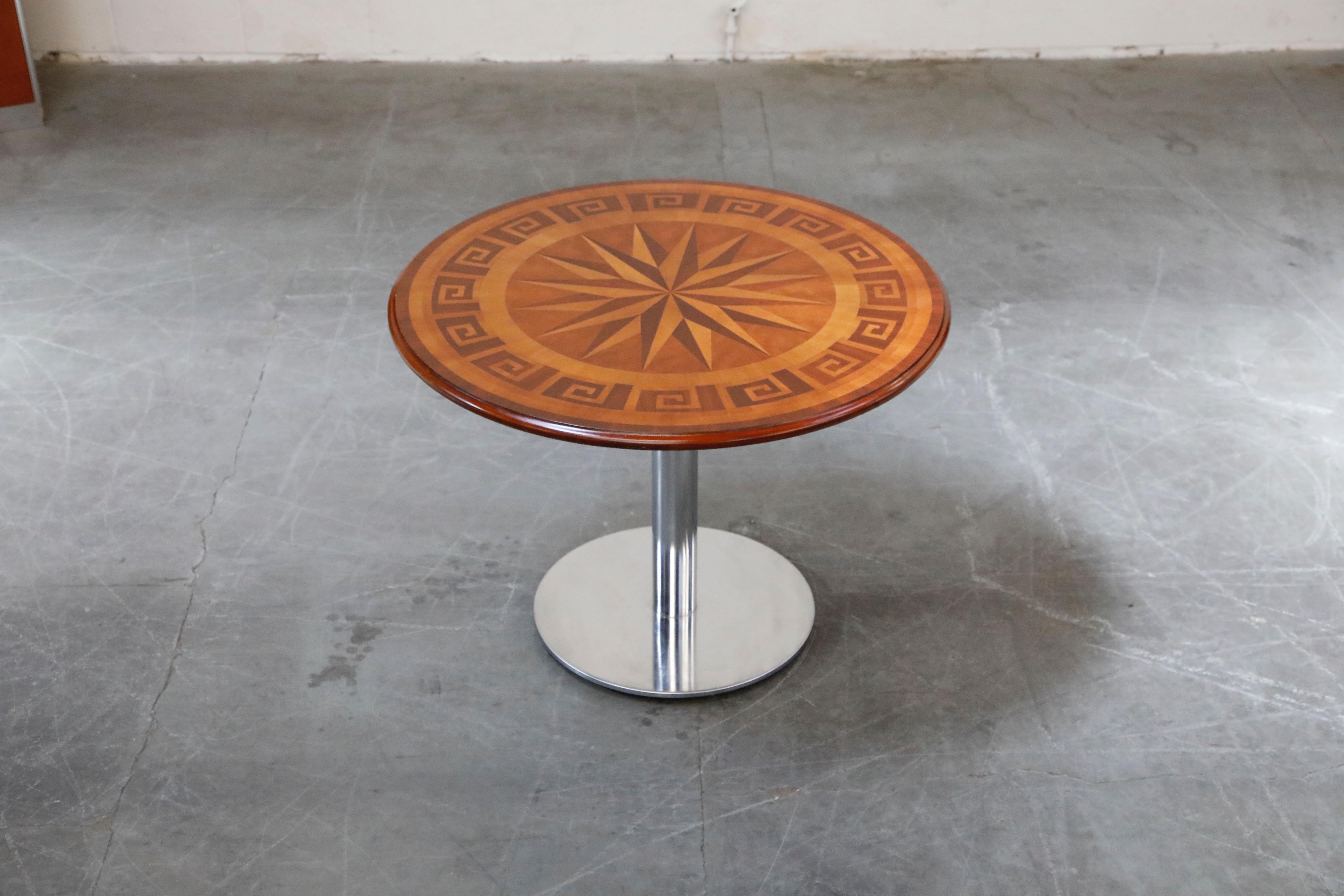 A wonderful dining / cafe table featuring inlaid marquetry wood with Greek key and nautical designs. Would also work wonderful as a center table. 40