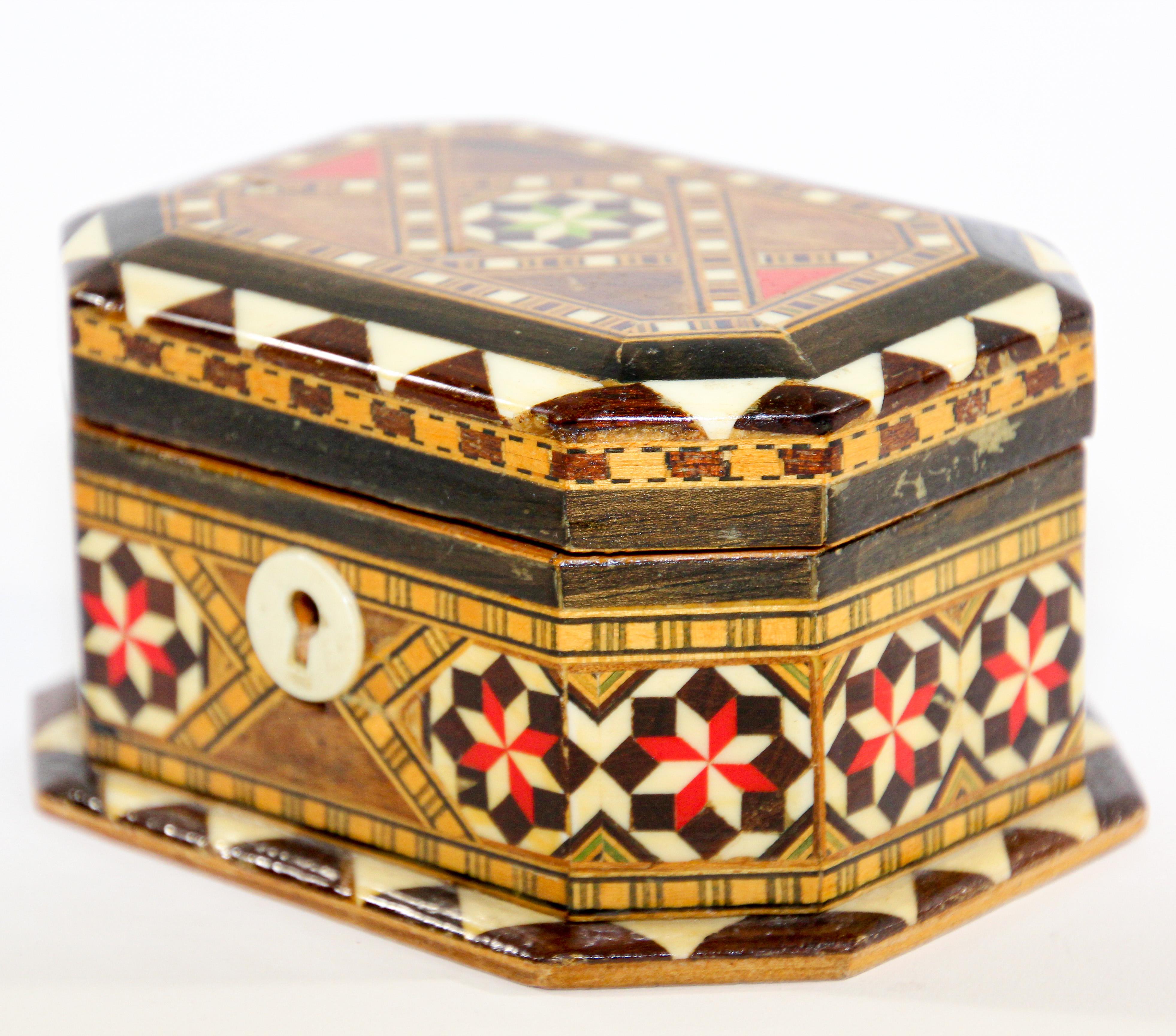 Spanish inlaid Marquetry trinket Moorish box.
Exquisite handcrafted Middle Eastern mosaic marquetry inlaid walnut wood box.
Handcrafted in Spain in the Moorish Syrian style with red velvet lined and a mirror.
Decorative box intricately and finely