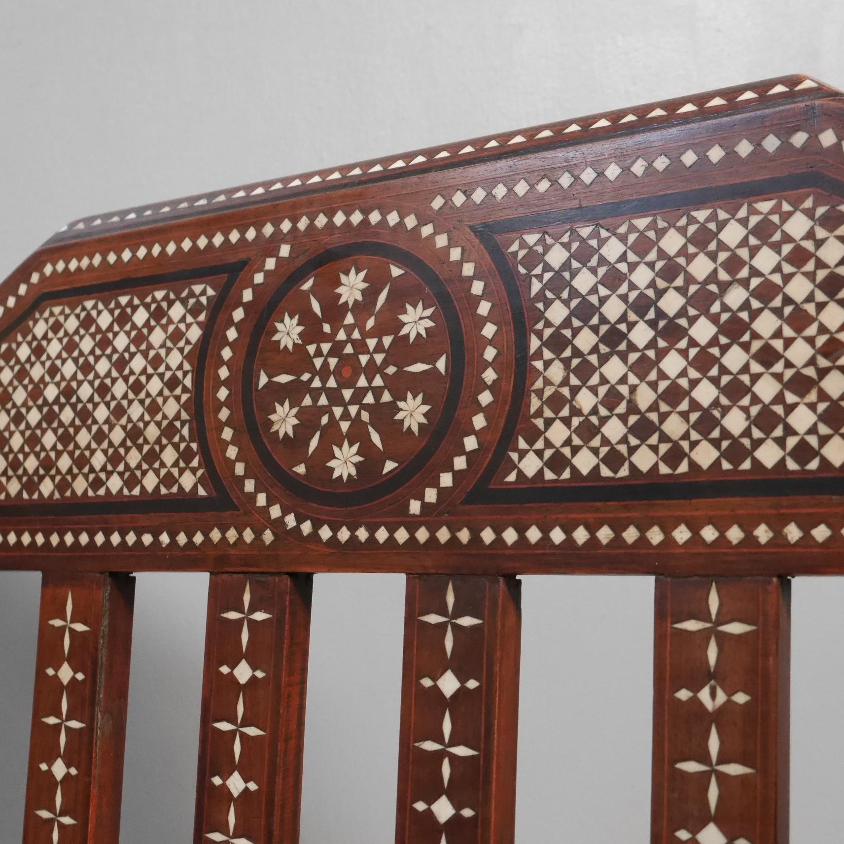 An inlaid moorish seat.
An exquisite & rare moorish seat / bench in the Hoshiarpur taste, in solid hardwood throughout with some outstanding detail to both the carpentry work and inlay. Raised on shapely legs with a stretcher to the base & profusely