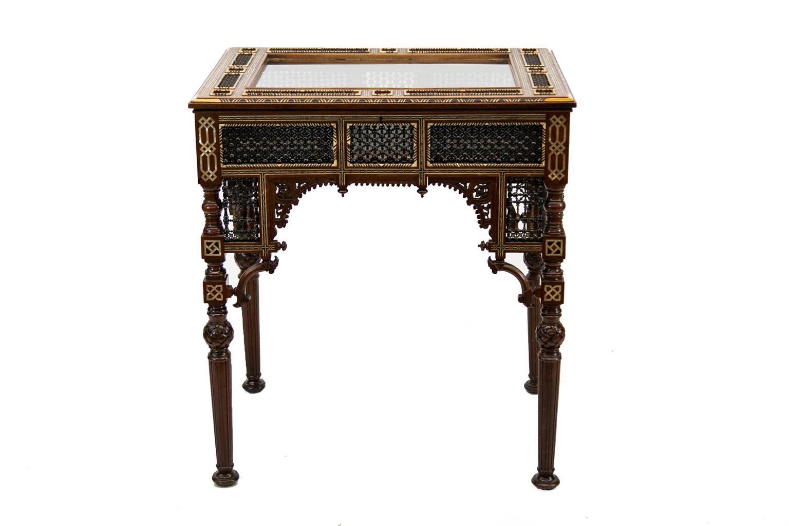 Inlaid Moroccan vitrine is profusely carved and inlaid with bone and exotic hardwoods. The glass top has some wear scratching but can be replaced at no cost if desired.