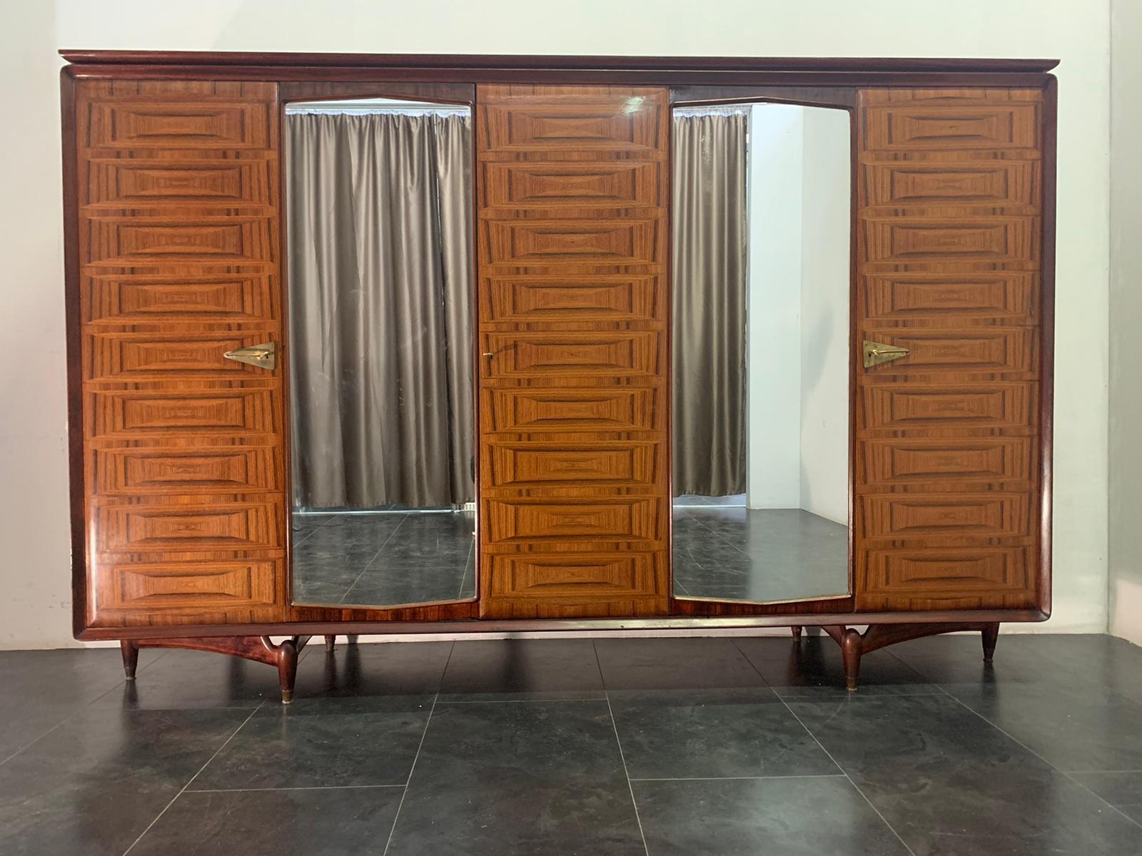 Closet of great quality brings 2 mirrors in the center, the doors are rounded and finely inlaid with veins of rosewood selection, geometric designs, create a luxurious optical effect, the doors are enclosed in a frame of solid rosewood rounded