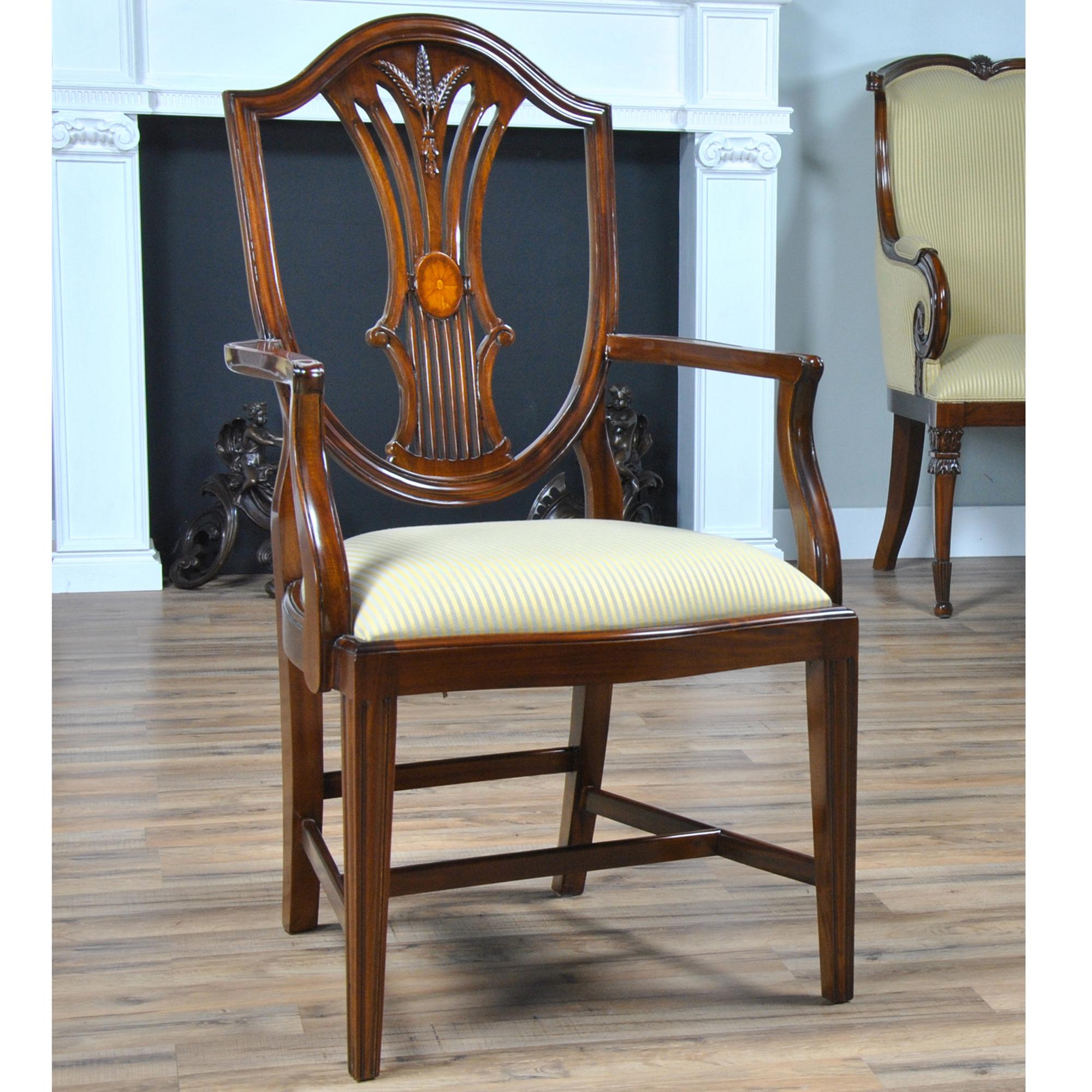 This set of 10 Inlaid Shield Back Chairs features 2 arm chairs and 8 side chairs. These shield back chairs are taller than many traditional shield back design chairs allowing the homeowner to see the beautiful workmanship in the chair backs even