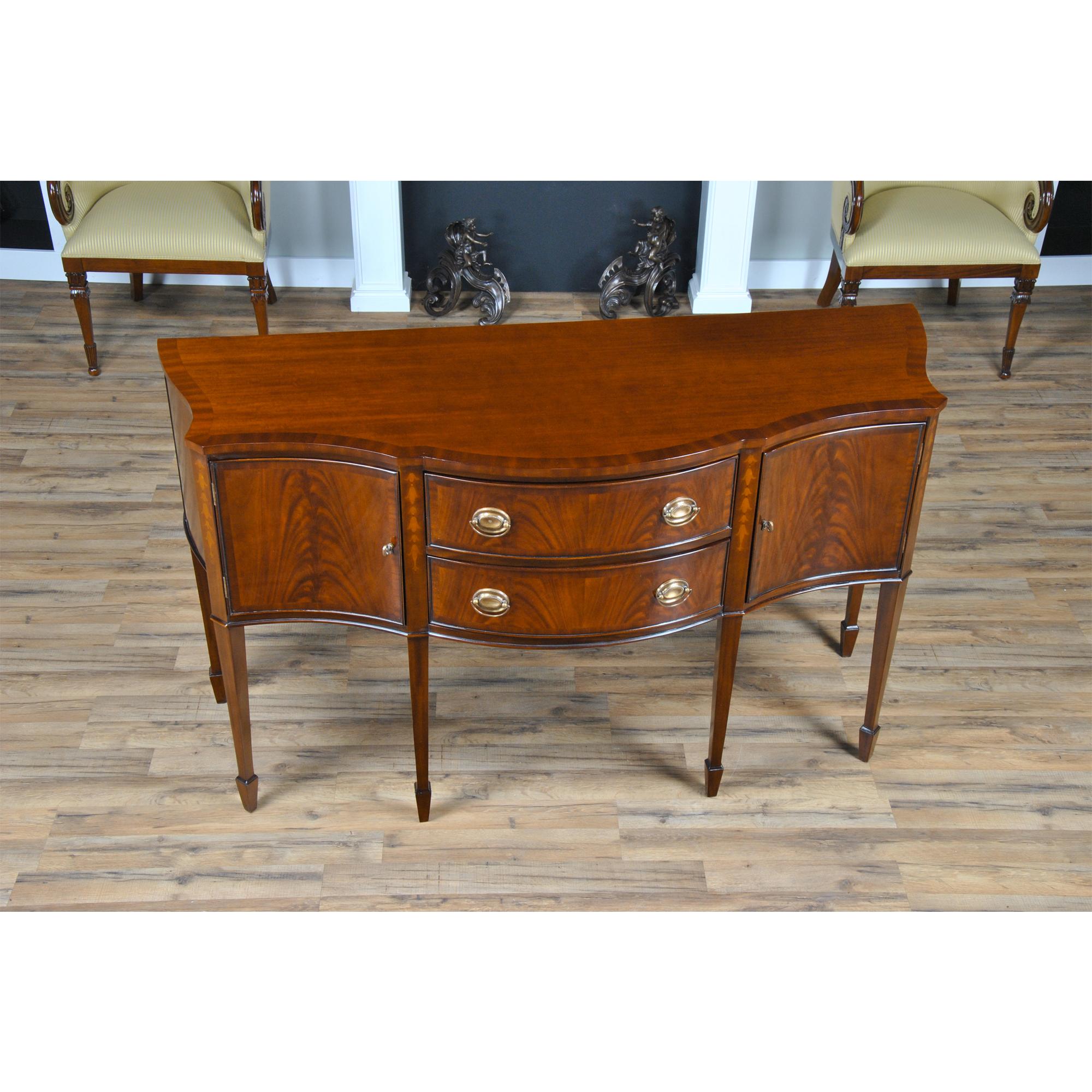 This sophisticated Inlaid Sideboard is beautifully appointed throughout and also boasts practical storage space. The serpentine shaped front is a classic design feature and this shape is highlighted on the top of the sideboard with lightly