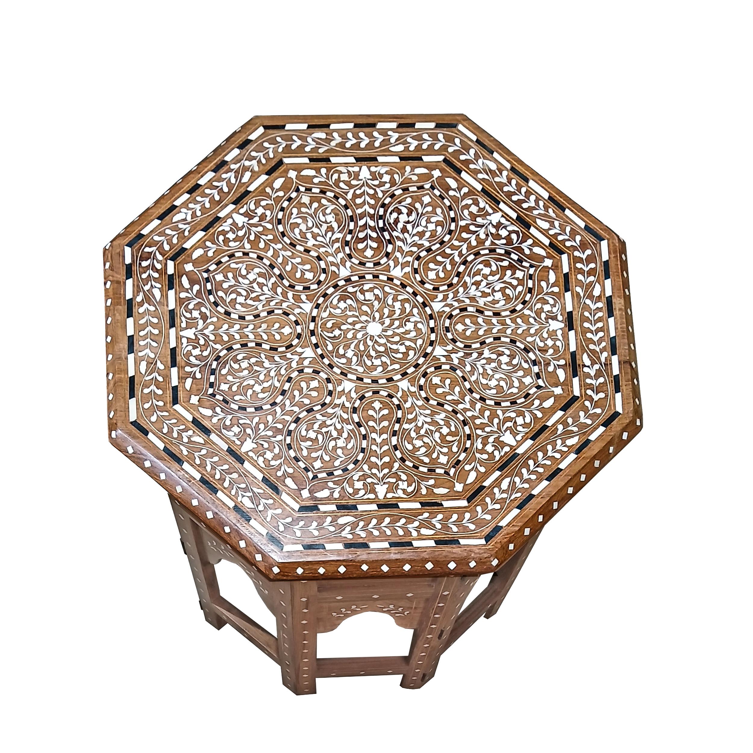 A small inlaid side table in octagonal shape, handcrafted in India out of seasoned teak wood and responsibly sourced animal bone inlay.  

Inlay is an ancient decorative technique that involves embedding delicate materials into the surface of an