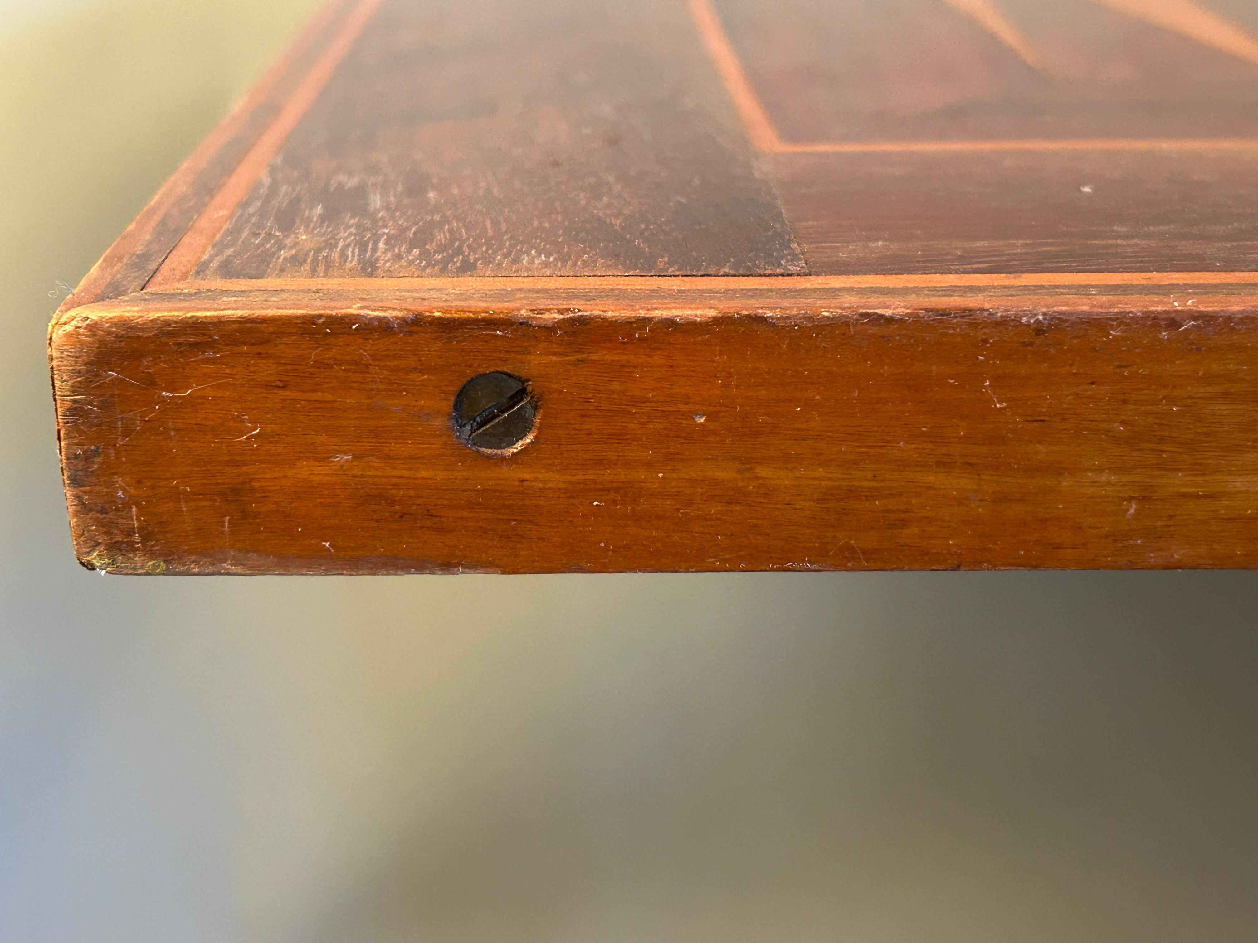Custom made tilt top table with multiple wood veneers create a wonderful inlaid backgammon board. Made in the early 20th century in the American Federal style. Nicely turned shaft sits on 3 nicely formed cabriole legs with pad feet. The top tilts up