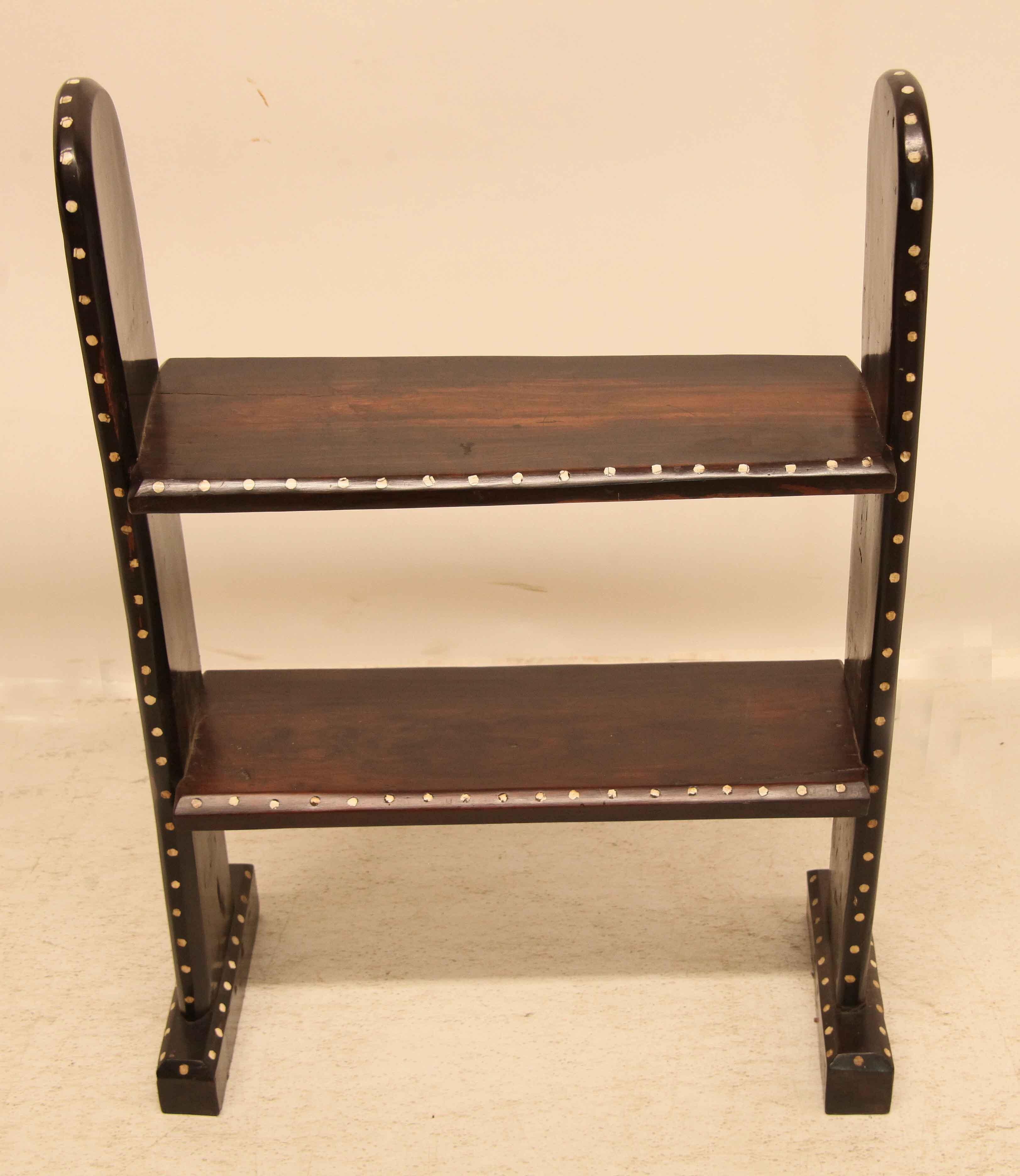 Inlaid two tier shelf,  this piece is very heavy and dark ,  we believe it originates from Africa although we cannot guarantee this.  It is inlaid with bone circles on all edges, front and back.  