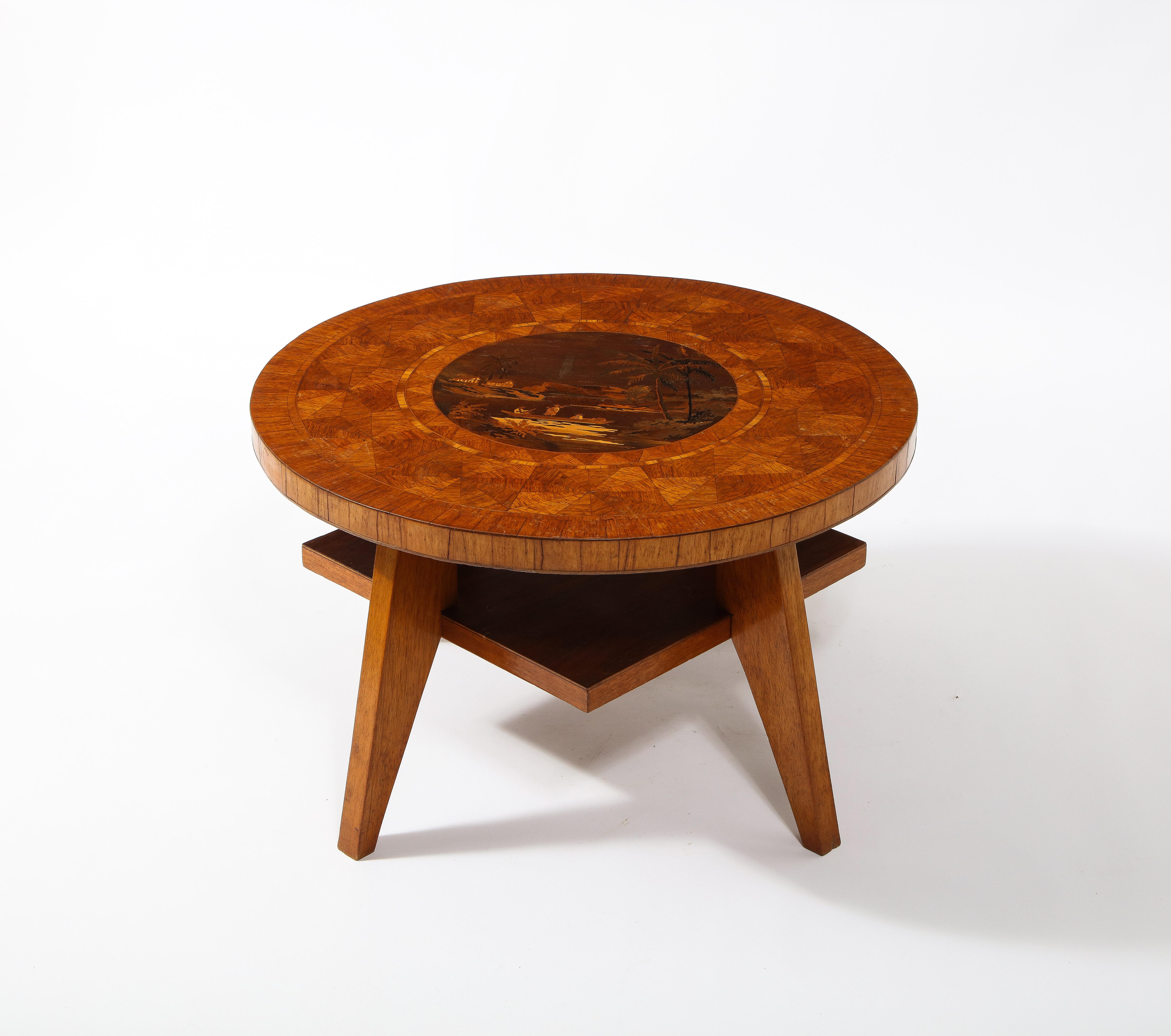 A Swedish inlaid table, very minimal construction on 4 legs, the square lower-tier and sturdy legs contrasted by a round top delicately inlaid with a tropical decor.