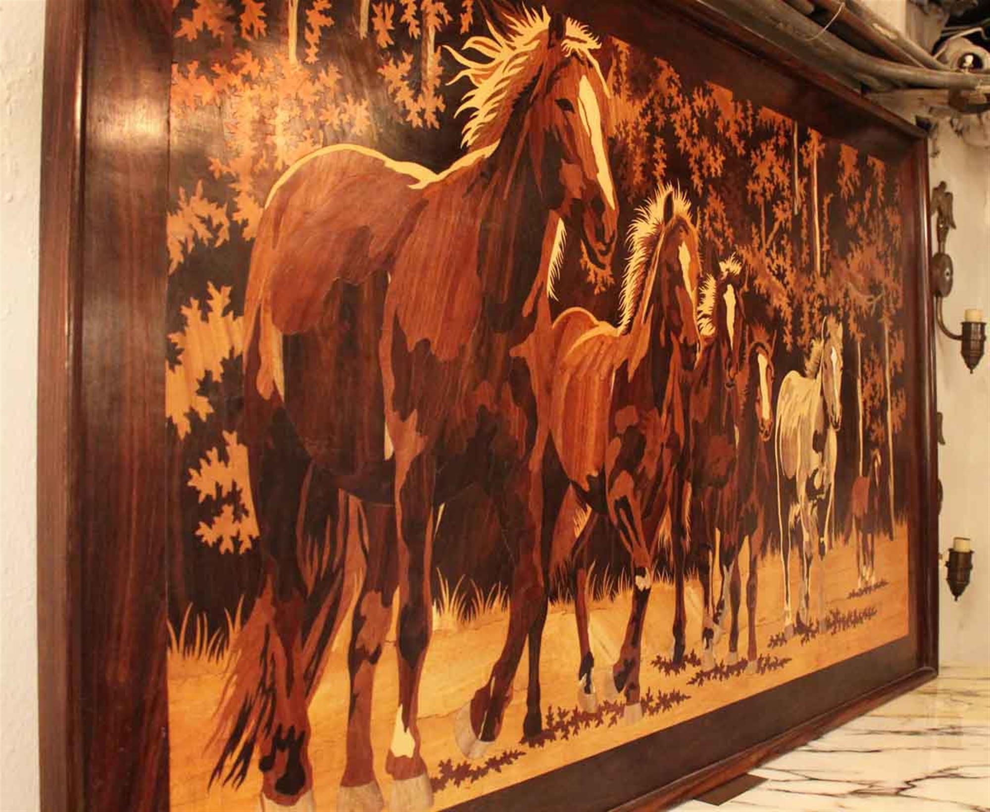 Framed 1980s wood inlay work of horses. This can be seen at our 2420 Broadway location on the upper west side in Manhattan.