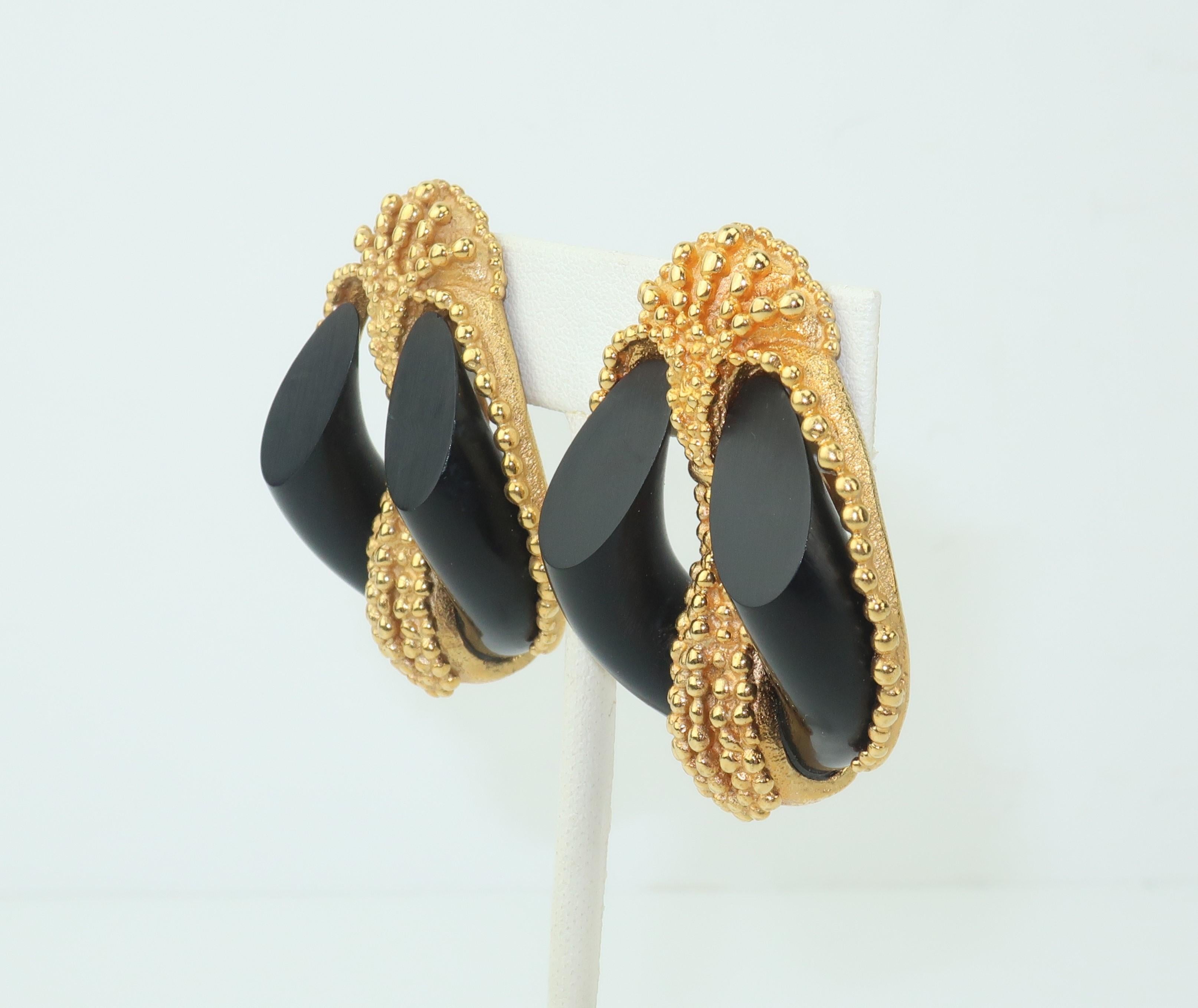 Inna Cytrine ornate gold tone earrings with detailed beading which frames a horseshoe shaped piece of black resin replicating ebony.  The design offers an eye catching combination of glamour and an organic form.  Signed to the back of each earring