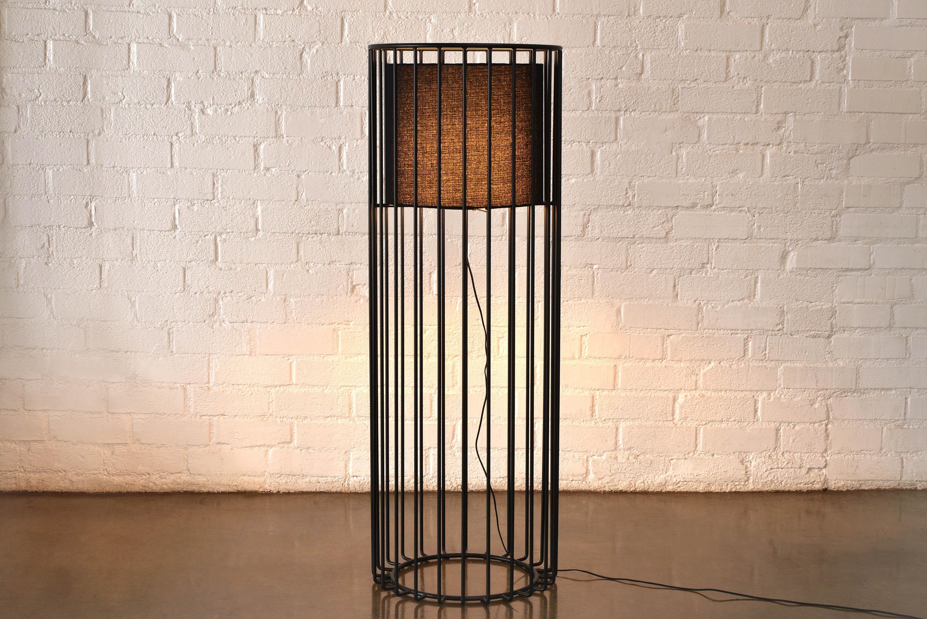 Inner Beauty Floor Light by Phase Design
Dimensions: Ø 50.8 x H 142.2 cm. 
Materials: Black linen and powder coated metal.

Solid steel bar available in a smoked brass, polished chrome, burnt copper, gloss or flat black and white powder coat. Powder
