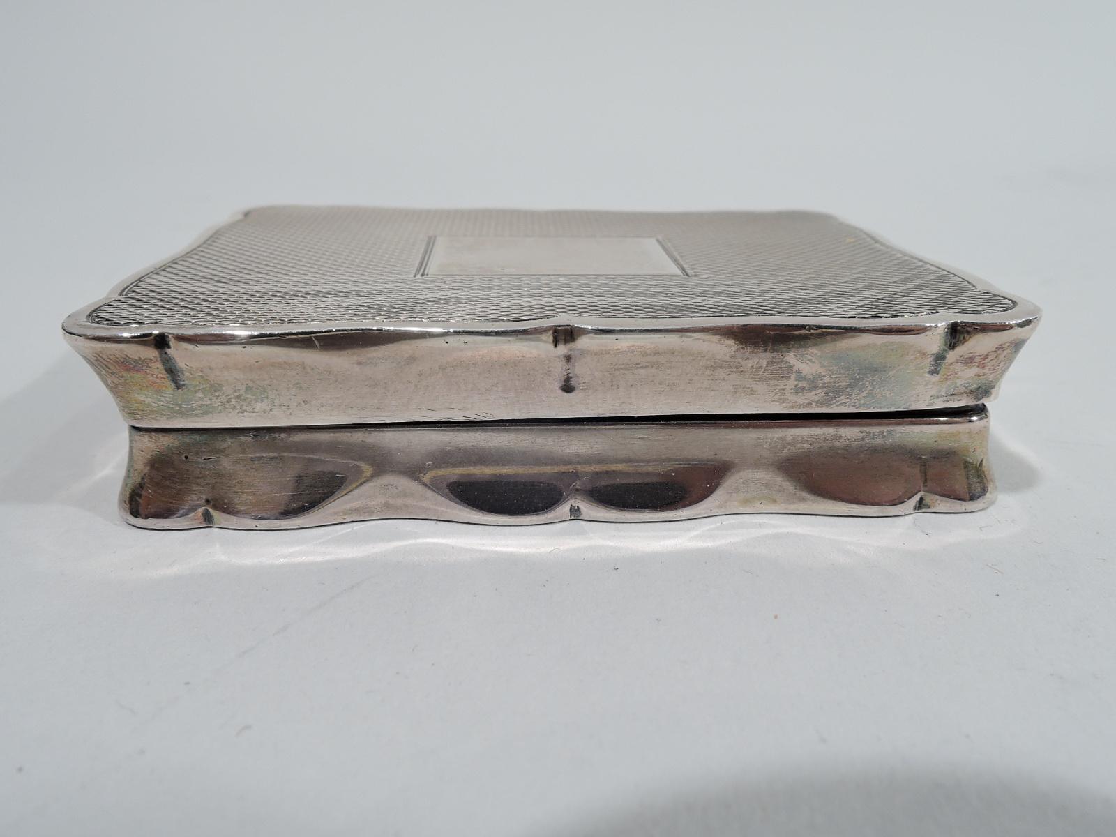 Elizabeth II sterling silver snuffbox. Made by Joseph Gloster Ltd in Birmingham in 1962. Rectangular with plain sides. Cover and bottom have engine-turned wave ornament and scrolled rims. Cover top has rectangular mono plate (vacant). Interior has