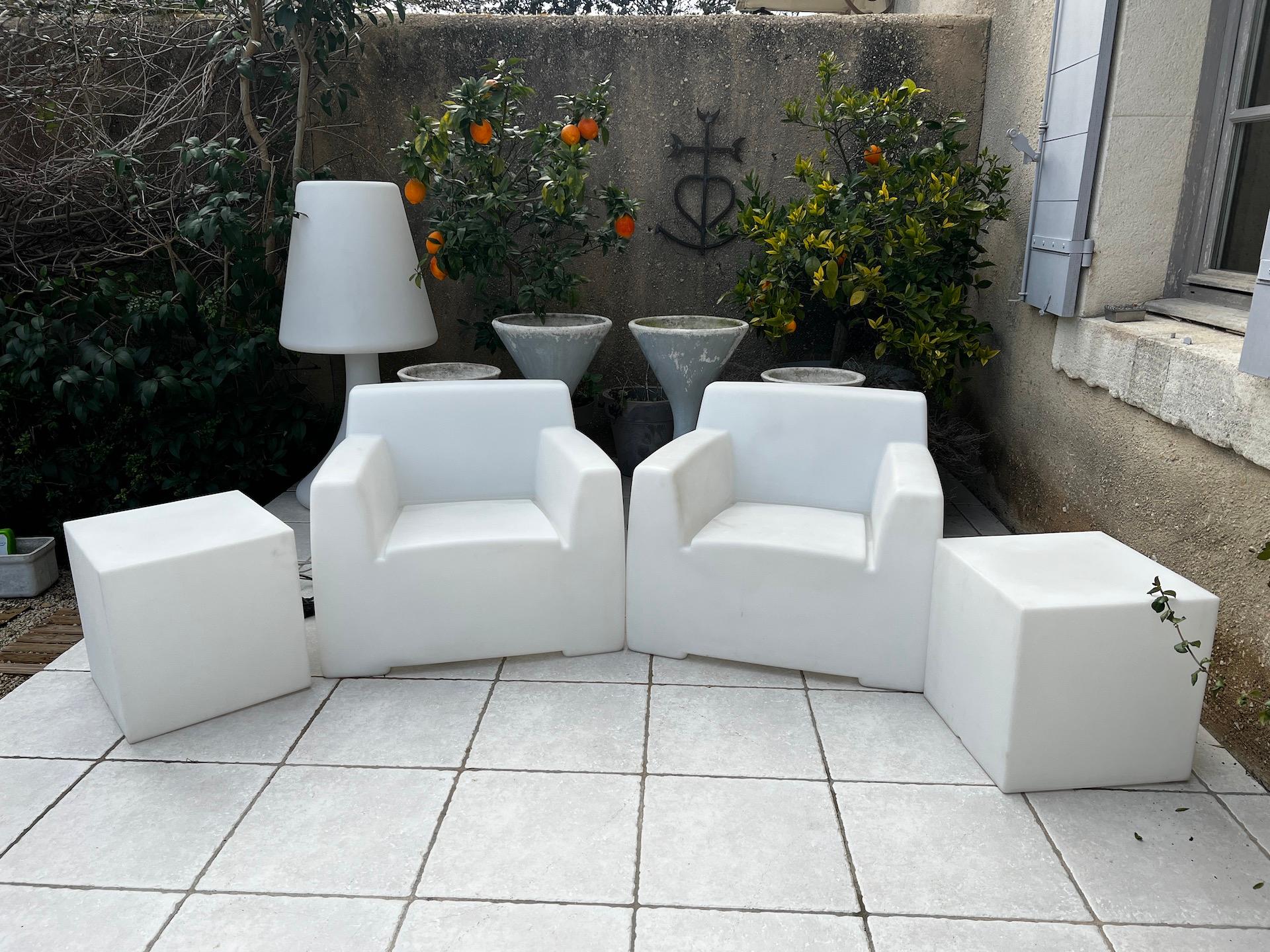 Garden set Paola Navone for Gervasoni including 2 armchairs and 2 plastic cubes in white opaline and white polyethylene. 
Armchairs : Height. 65 x Width. 72 x Depth. 72 cm 
Cube : Height. 43 x Width. 43 x Depth. 43 cm.