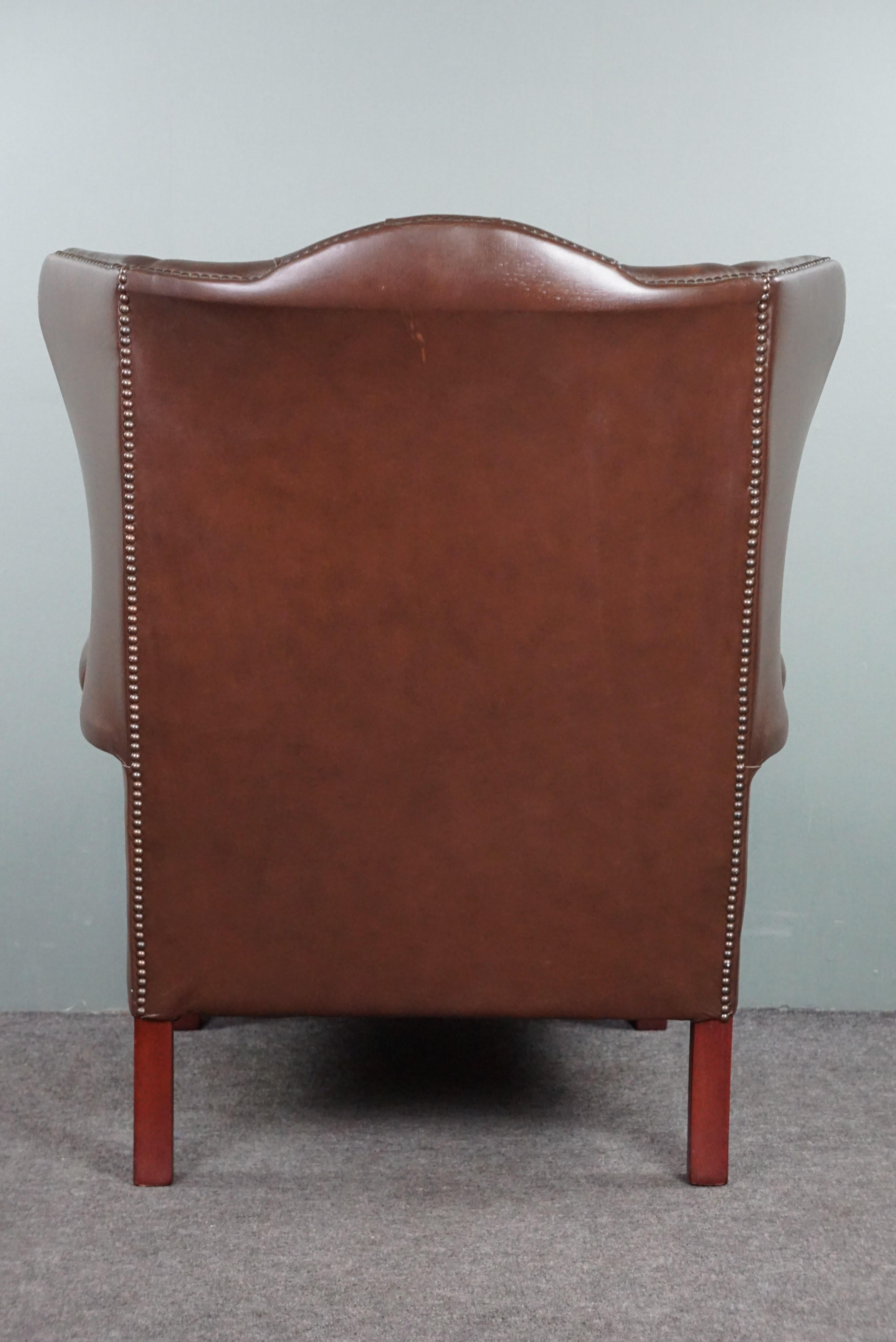 Leather Insanely colored Chesterfield wingback armchair. For Sale