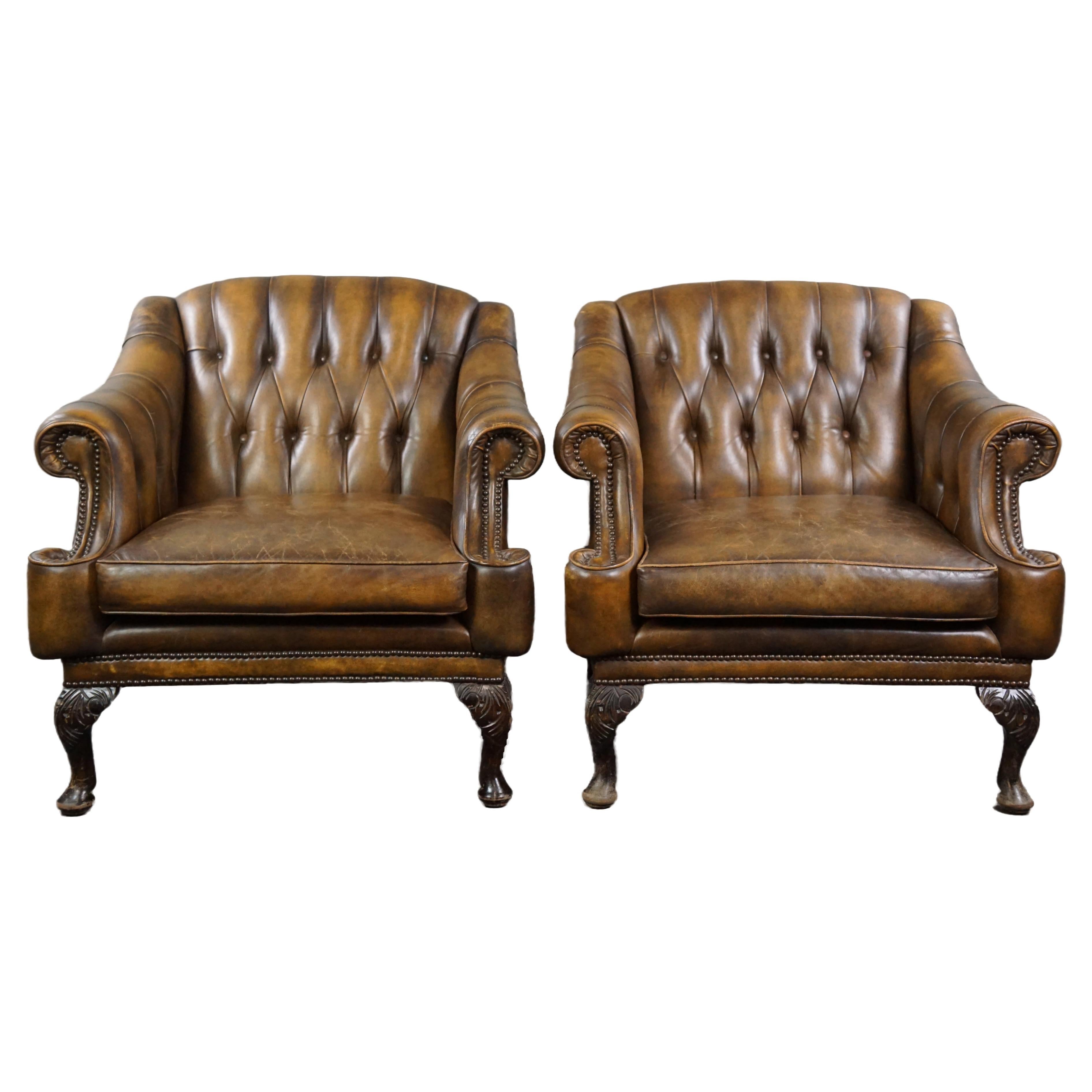 Insanely unique set of two cowhide leather Chesterfield armchairs/arm chairs For Sale