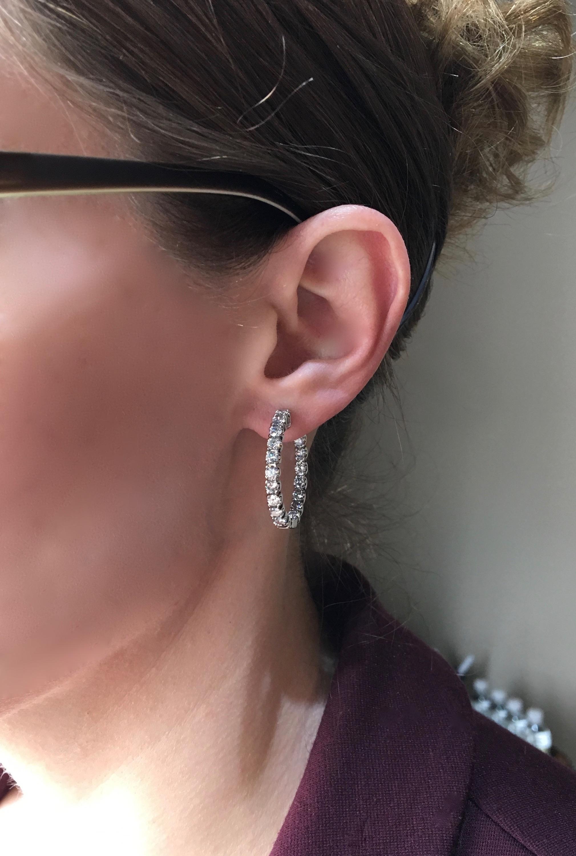 Approximately 2.75CTW inside out diamond hoop earrings crafted in 14K white gold.

Diamond Carat Weight: Approximately 2.75CTW 
Diamond Cut: Round Brilliant Diamonds
Color: Average G-J
Clarity: Average I
Metal: 14K White Gold
Marked/Tested: Stamped