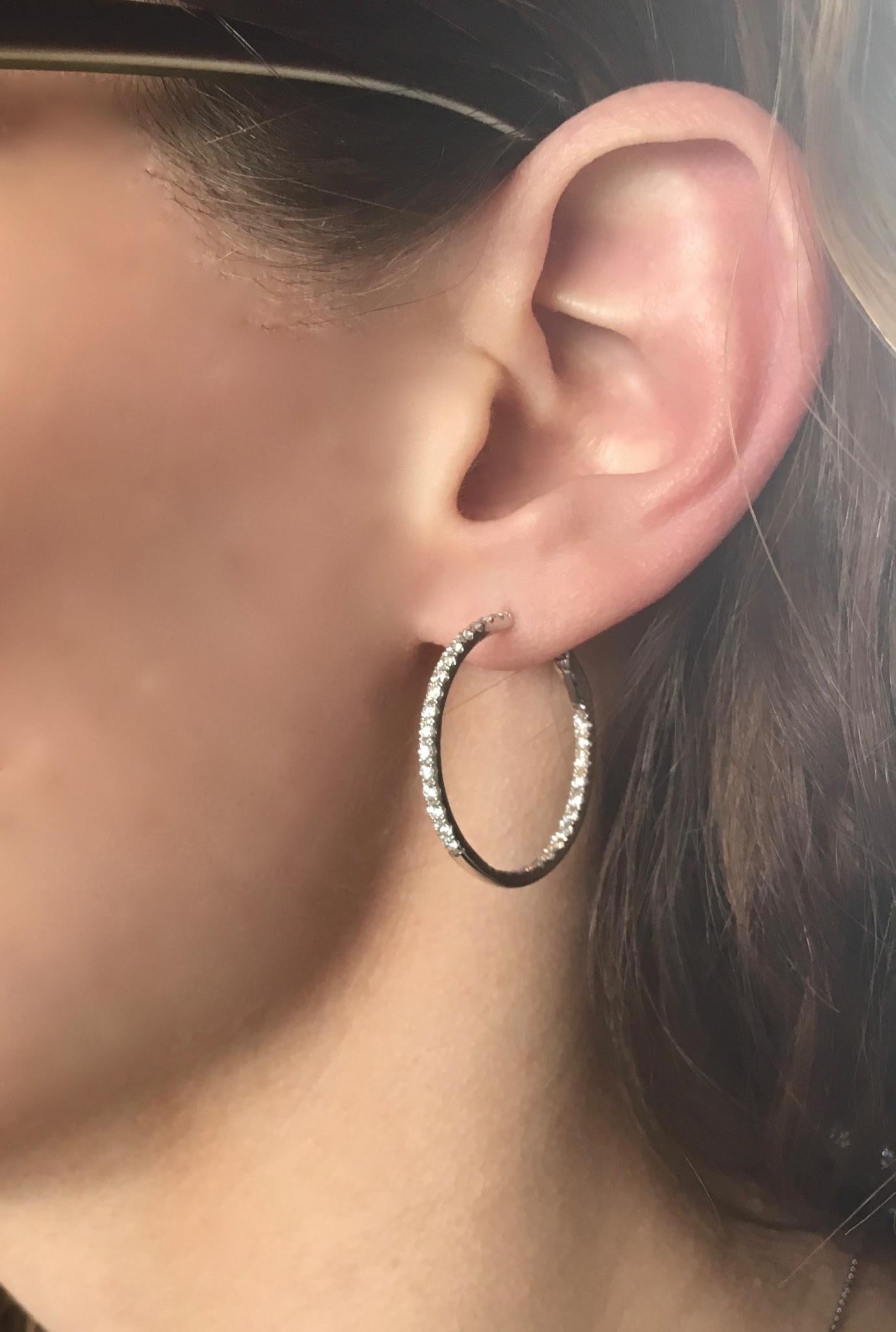 These inside out diamond hoop earrings feature approximately 1.20ctw of Round Brilliant Cut Diamonds set in 14K white gold.

Diamond Carat Weight: Approximately 1.20CTW 
Diamond Cut: 60 Round Brilliant Diamonds
Color: Average G-I
Clarity: Average