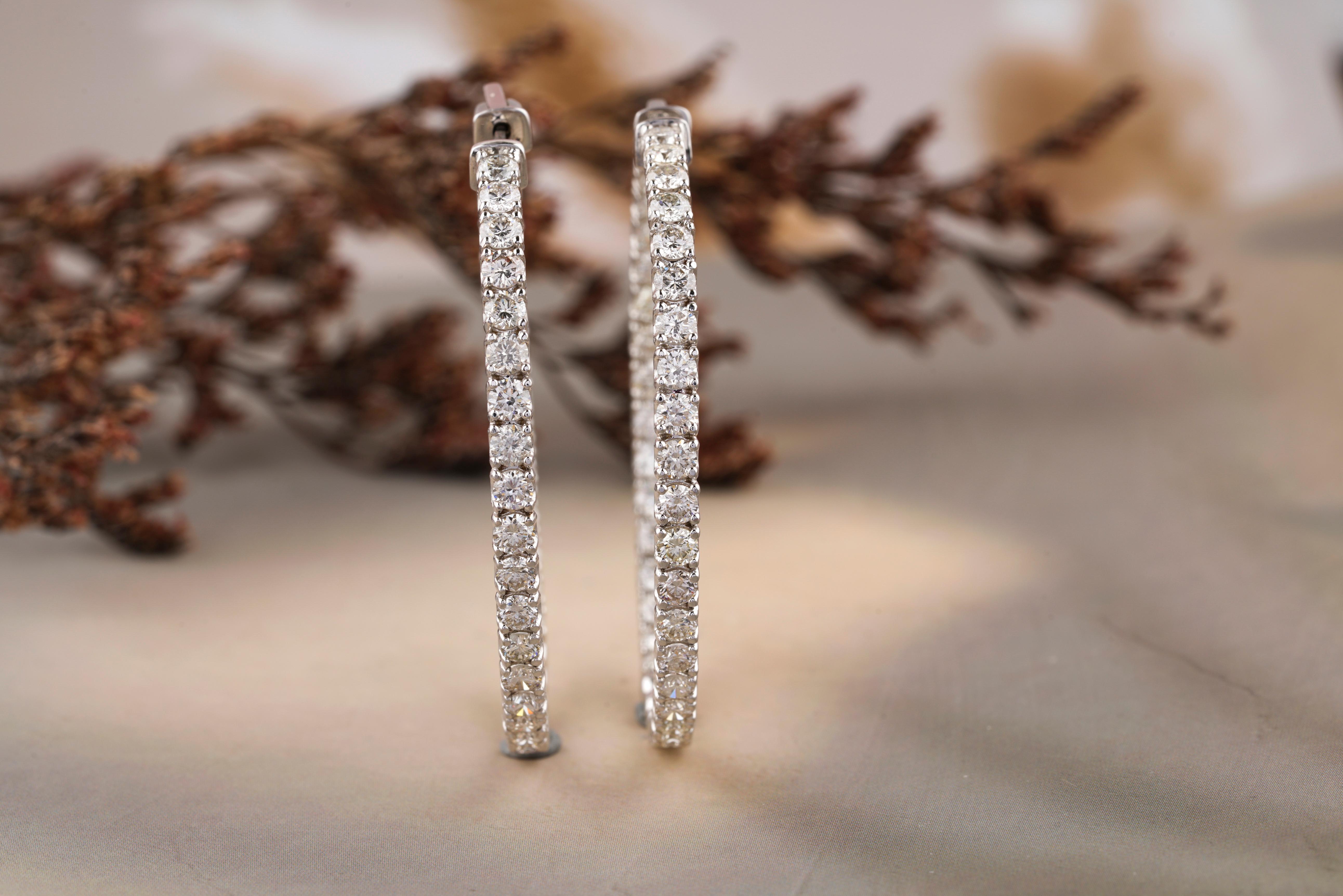 The Inside Out Diamond Hoop Earrings in 18K Solid Gold are a stunning and luxurious accessory. These hoop earrings feature a unique design where diamonds are set both on the outside and the inside of the hoop, ensuring that they catch and reflect