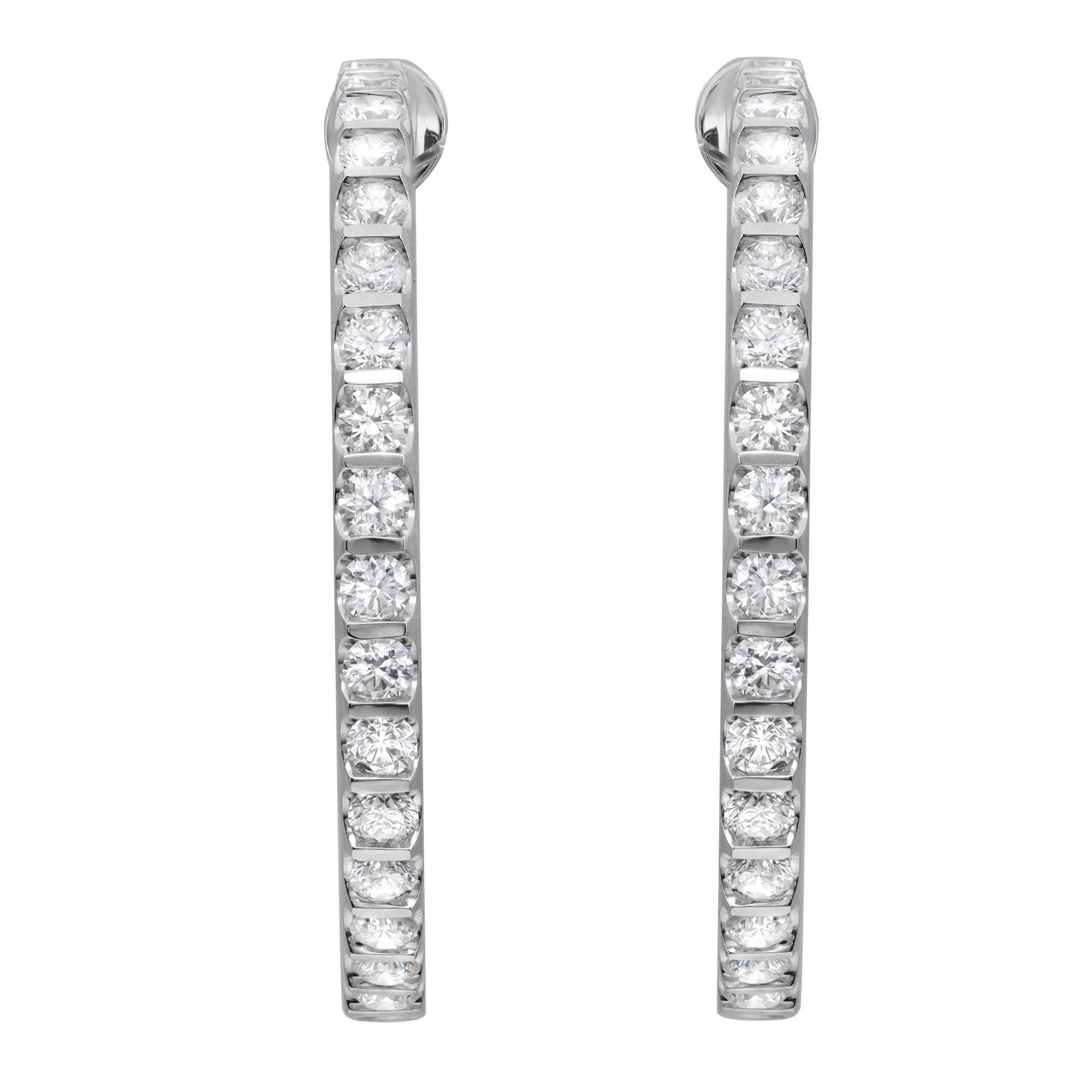 Elevate any attire with these dazzling diamond inside-out hoop earrings. Crafted in lustrous 18K white gold, each earring sparkles from every angle with a row of glistening round brilliant cut diamonds along the outside front and inside back of the