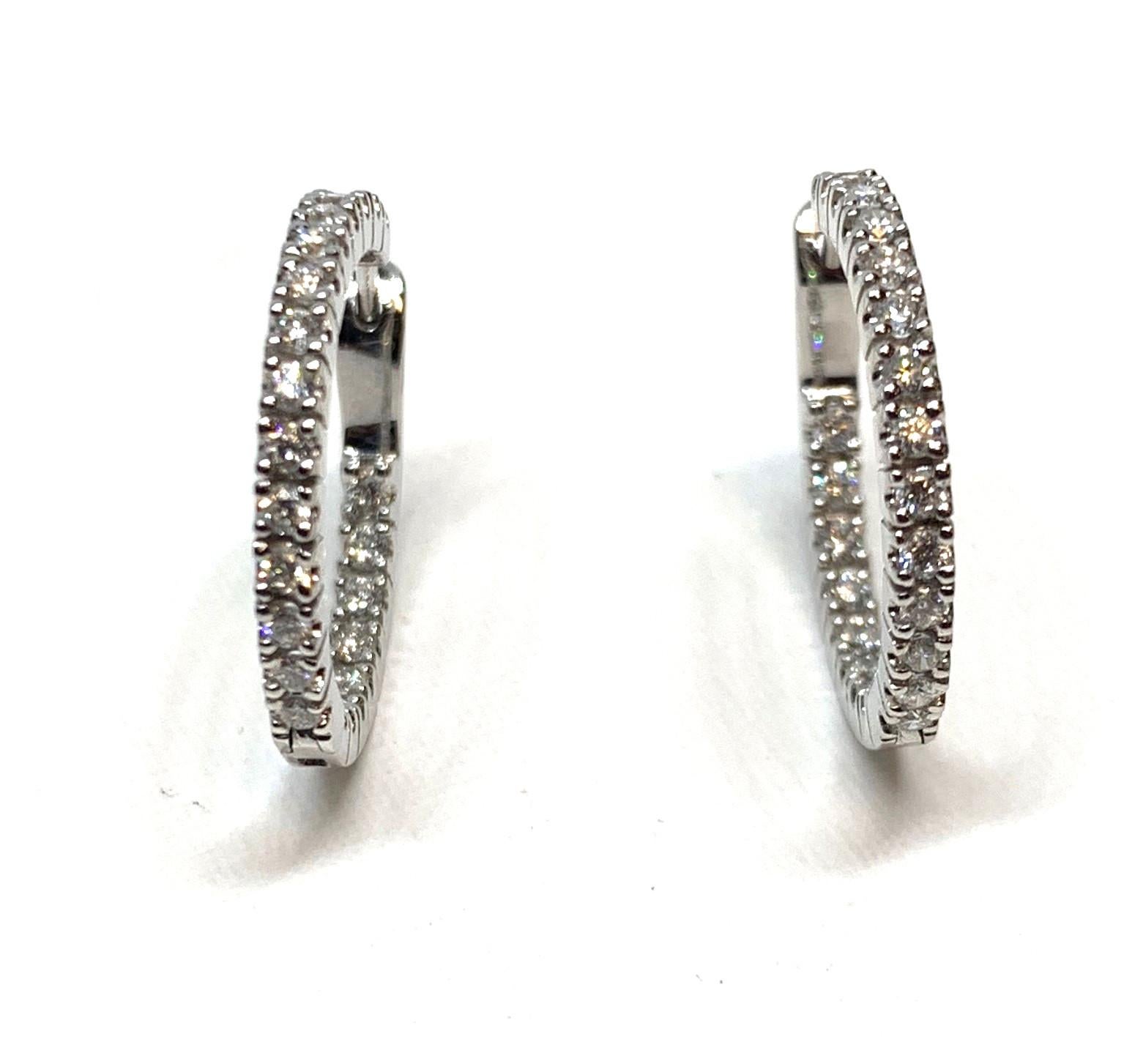 These diamond hoops are a an updated twist on the classic style. They are set with diamonds on the outside as well as the inside of each hoop! Forty-four round brilliant cut diamonds  provide endless sparkle. Made of 18k white gold. A perfect gift