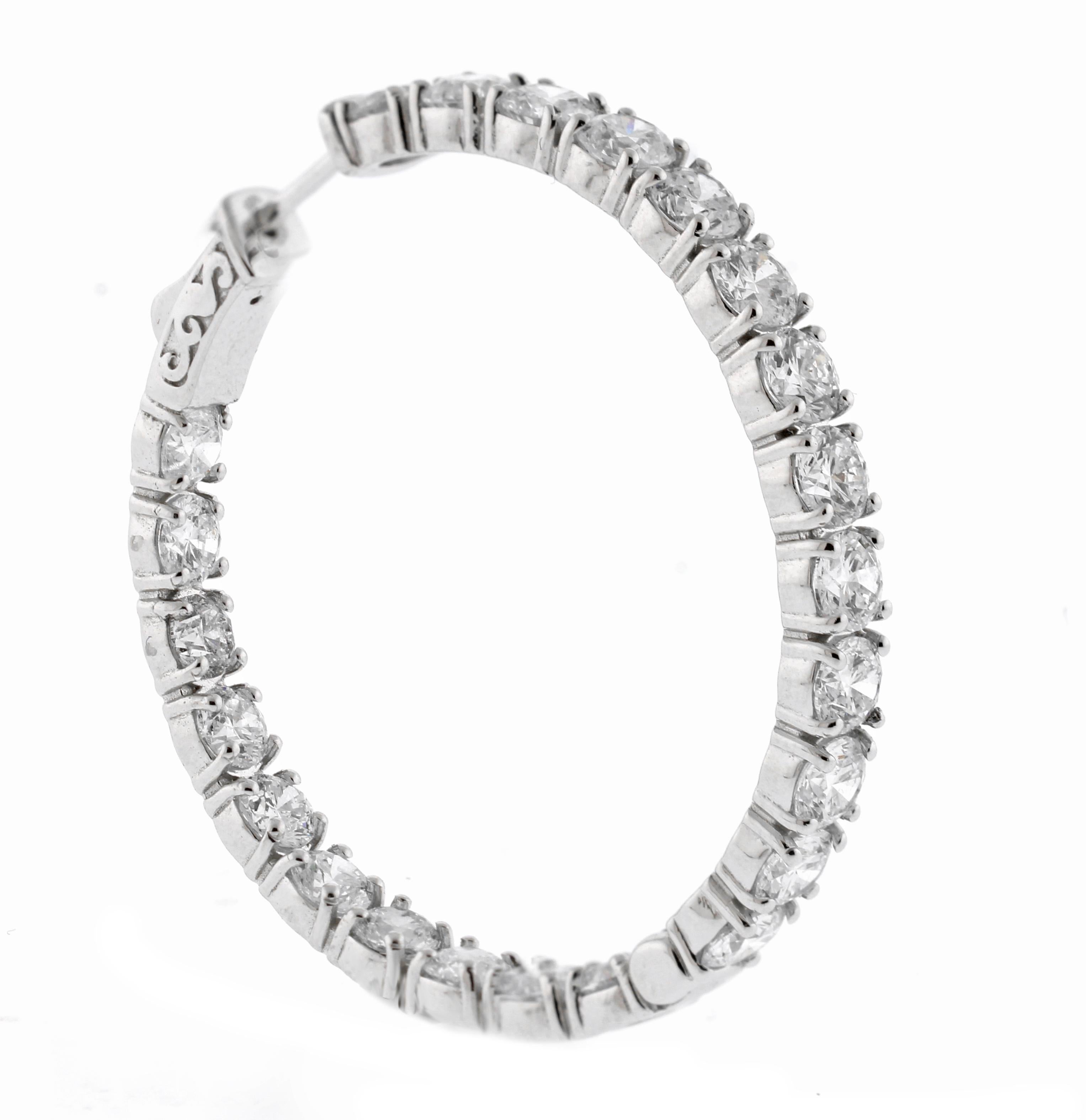 From Pampillonia jewelers, a pair in diamond hoop earrings. The full circle of diamonds are brilliant from any angle. 46 Diamonds weigh 11.13 carats, I color ad VS clarity. The earrings are a full 1 and 3/8th of an inch in diameter