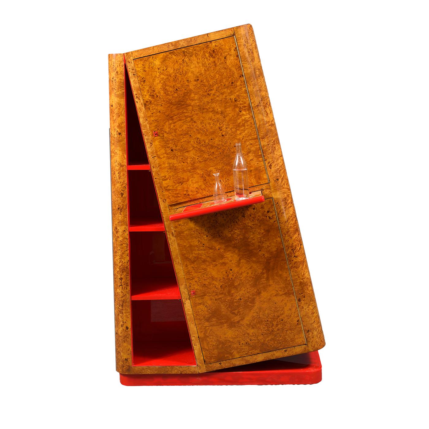 A dynamic design of Futuristic inspiration playing with a sense of impactful deceptive disequilibrium, this cupboard is sure to take center stage in eclectic modern homes. Vivid red accents the interior and the base, while the wooden external