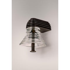 Insulator A Clear Glass and Dark Brass Sconce by Novocastrian