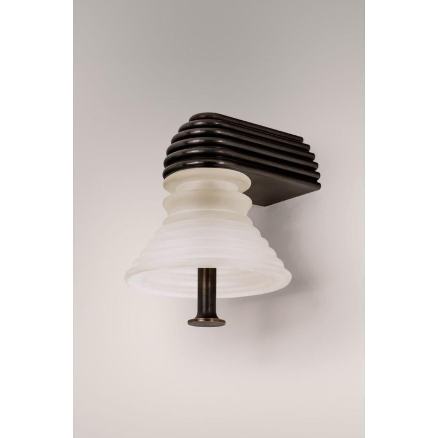 Insulator A Frosted Glass and Dark Brass Sconce by Novocastrian
Dimensions: Ø 14 x H 21 cm.
Materials: Frosted glass and dark brass.  

All products are available in custom dimensions and finishes. Rods can be cut to length or provided at longer