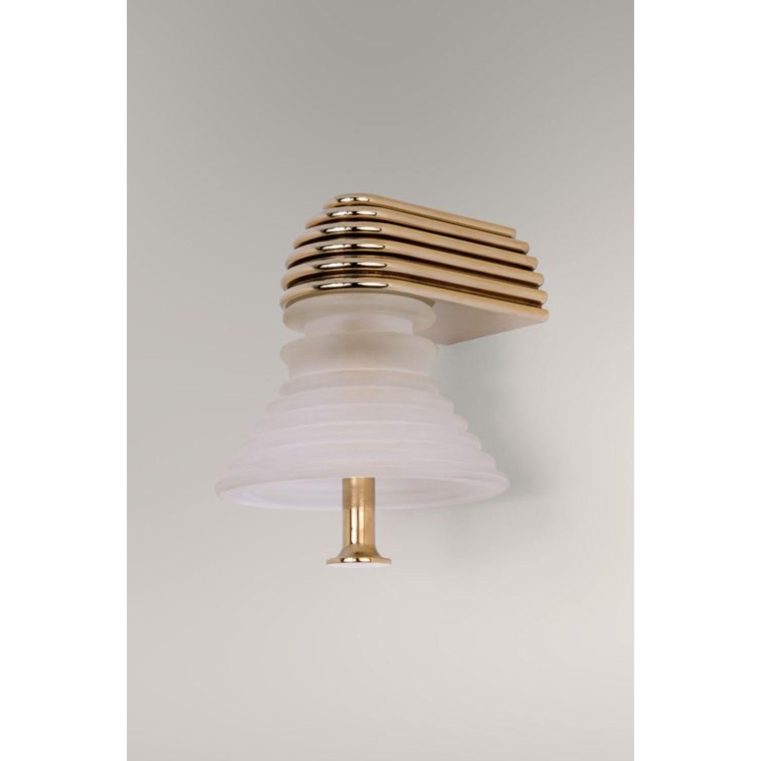 Insulator A Frosted Glass and Polished Brass Sconce by Novocastrian
Dimensions: Ø 14 x H 21 cm.
Materials: Frosted glass and polished brass.  

All products are available in custom dimensions and finishes. Rods can be cut to length or provided at