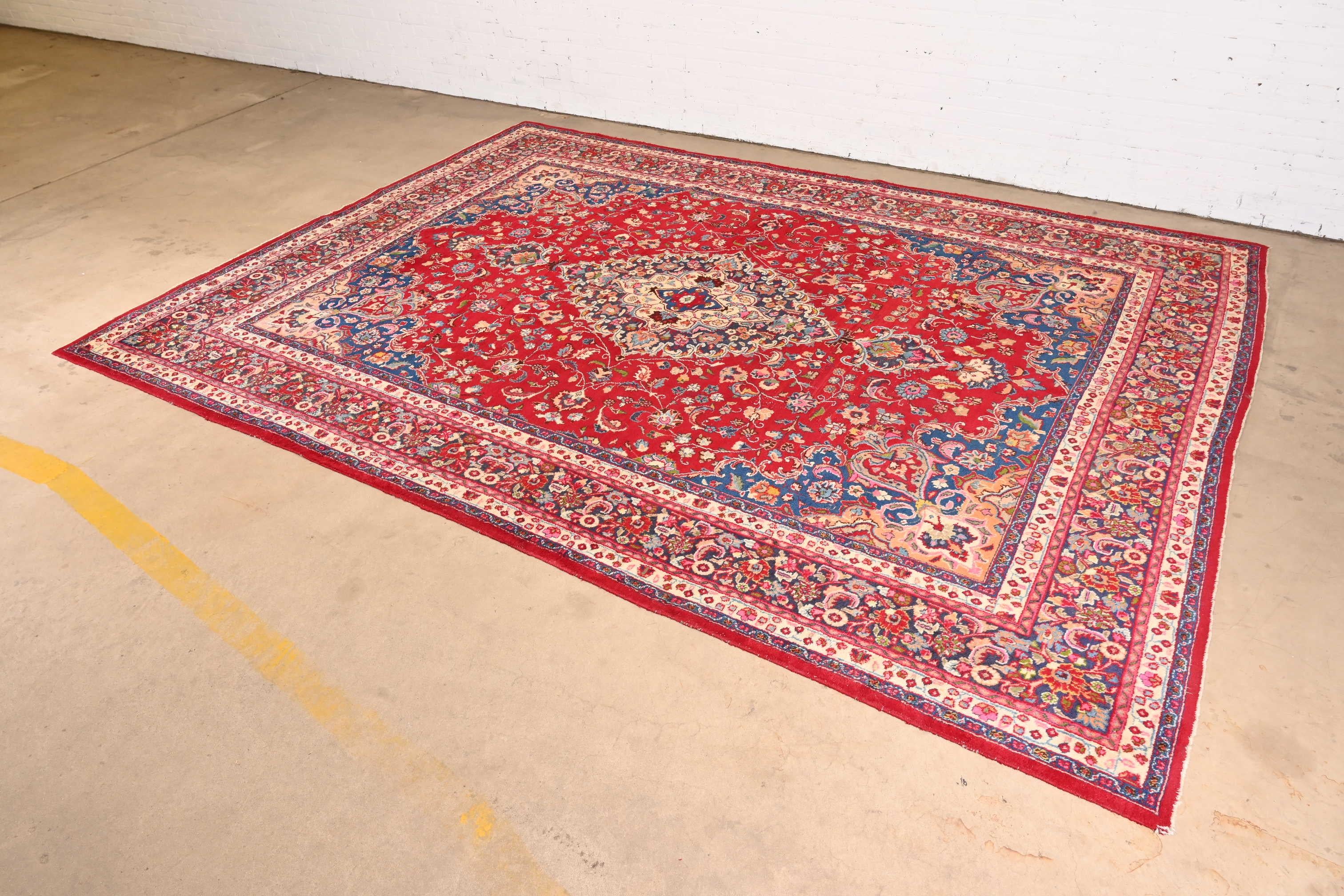 A gorgeous vintage hand-knotted Persian Tabriz room size wool rug

Mid-20th Century

Classic design, with floral sprays and bouquets. Predominant colors in red, blue, pink, and ivory.

Measures: 9