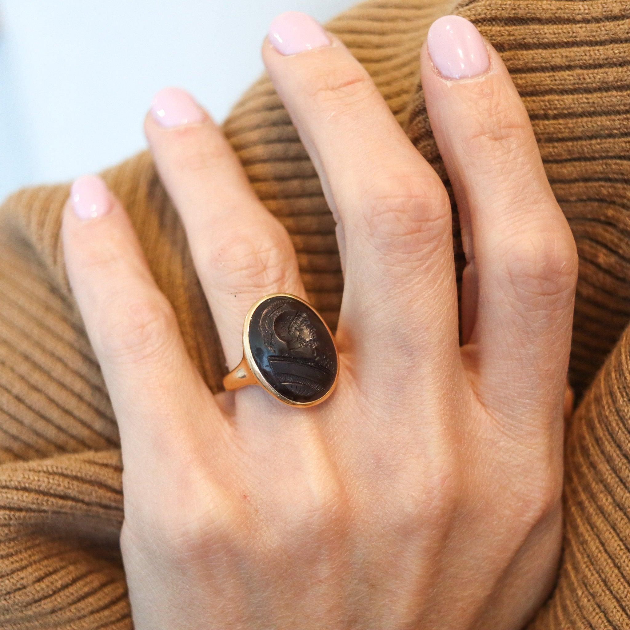 An antique intaglio signet ring.

This is a gorgeous antique signet ring, created in England during the Edwardian period, back in the 1900. The ring has been crafted with smooth lines in solid yellow gold of 14 karats with polished finish. It is