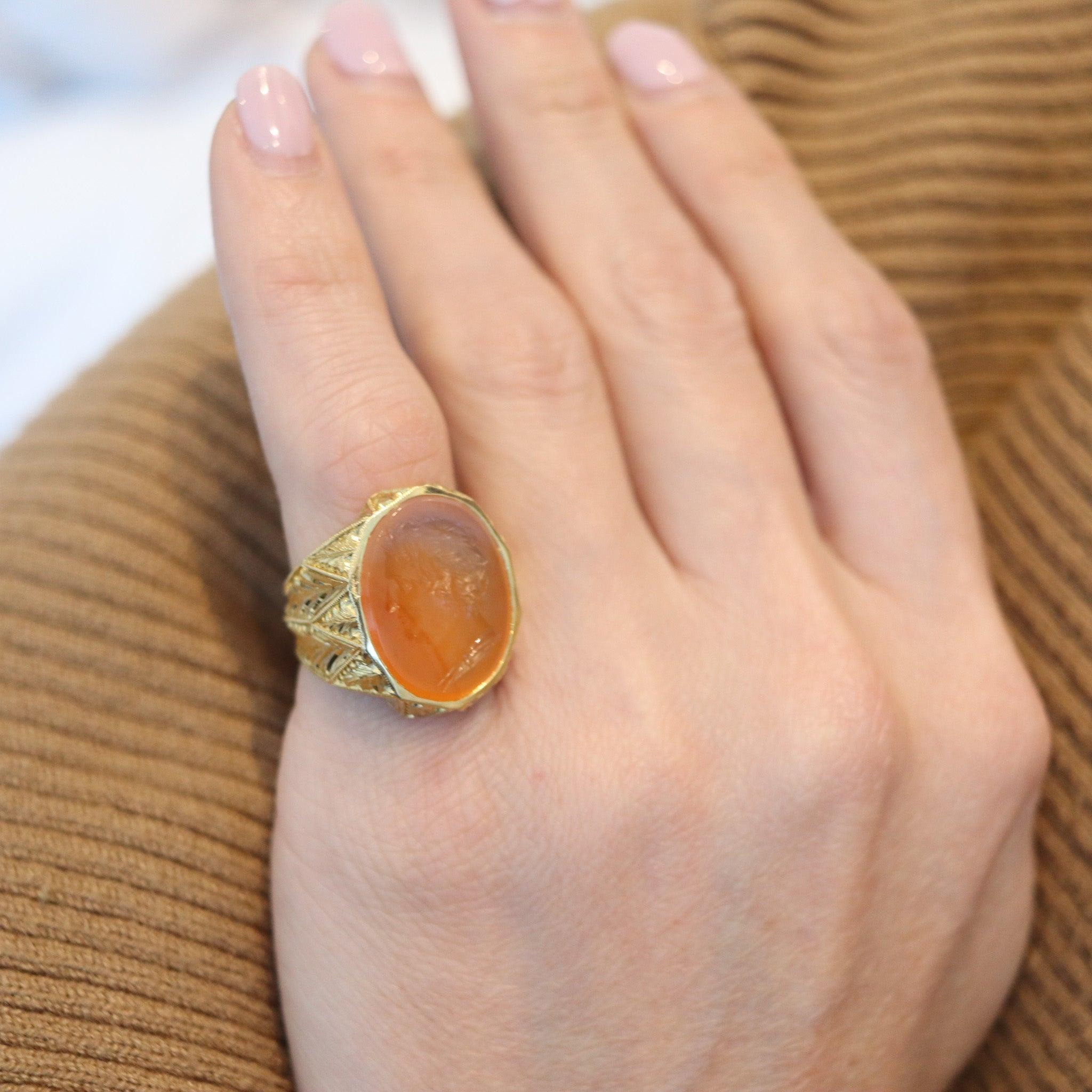 An antique intaglio signet ring.

This is a fabulous antique intaglio signet-ring created in America during the art-deco period, between the 1915 and 1920. The ring has been masterfully crafted with geometric patterns in solid yellow gold of 18