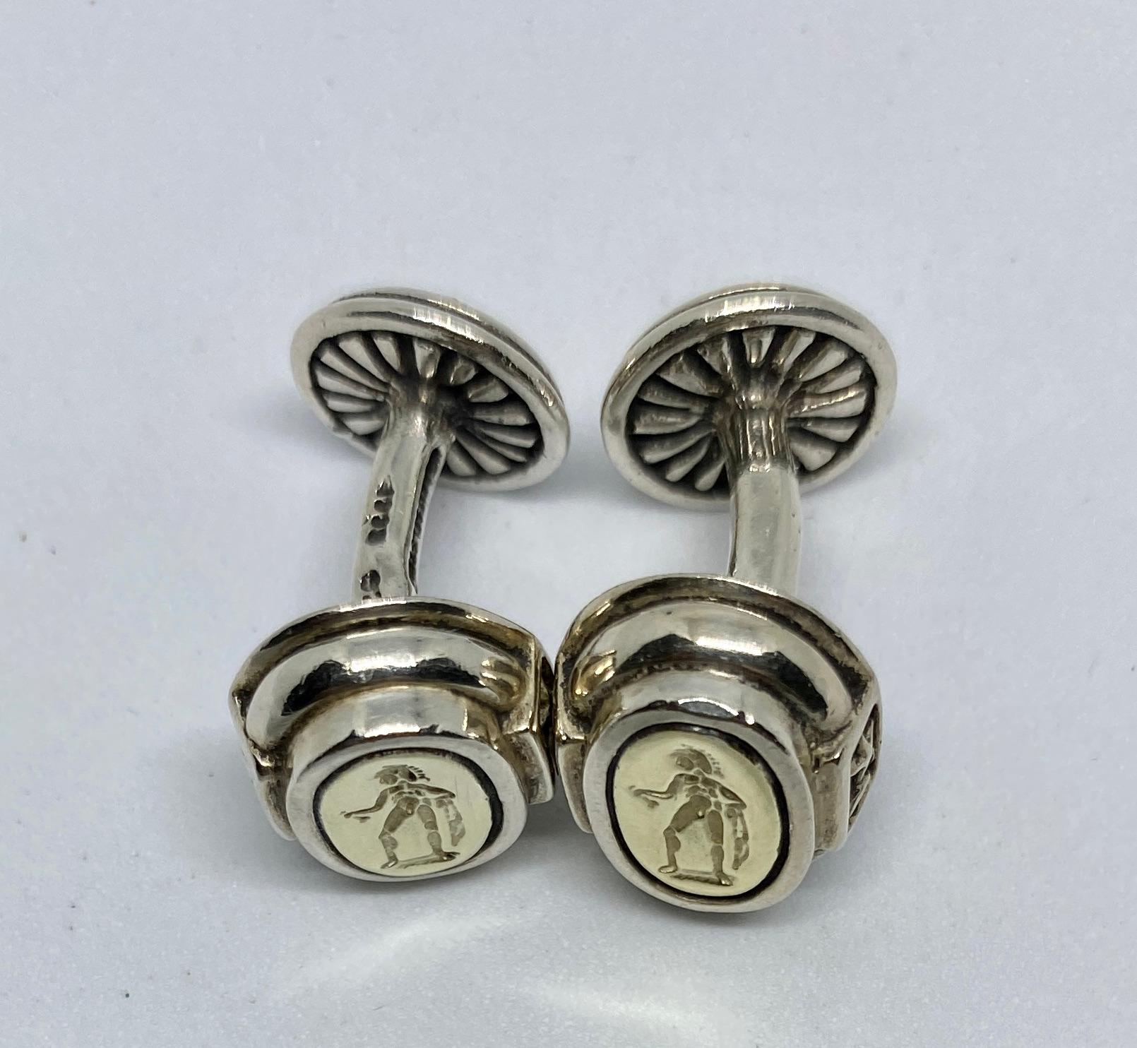 An extremely rare, highly collectible pair of cufflinks by Barry Kieselstein-Cord featuring a classical motif in yellow gold set in sterling silver.

The oval faces measure 15mm by 12.5mm and are backed with backs measuring 12mm in diameter