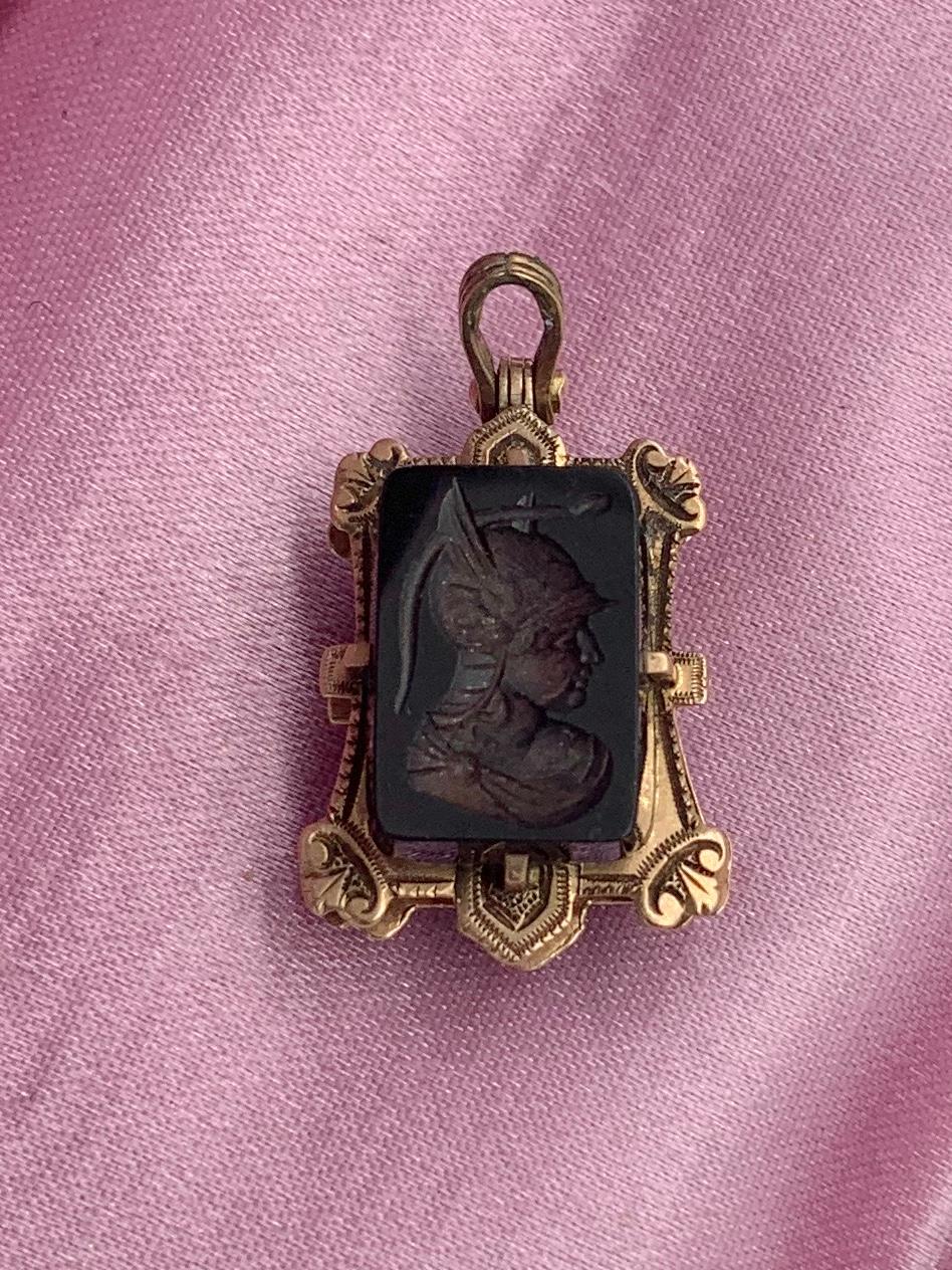 A rare and wonderful antique Belle Epoque, Victorian locket pendant with a beautiful Intaglio of a Roman Warrior God with a winged helmet, Mercury or Hermes, in Black Onyx.  The wonderful locket is 10 Karat Rose Gold with beautiful Etruscan details