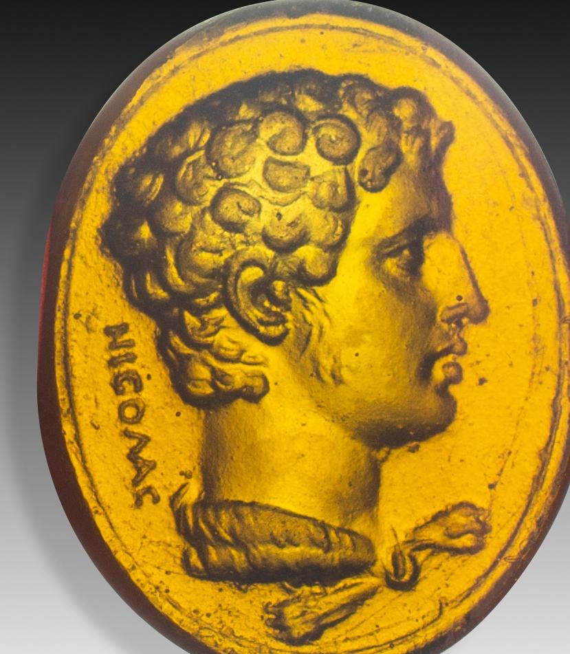  Entaille ou camée, portrait. Le verre. Peut-être Italie, 19e siècle. 
Profil d'un jeune homme aux cheveux courts et bouclés, portant un grand collier ou un ornement de cou. Ces pièces ont été créées en grand nombre car elles étaient très prisées