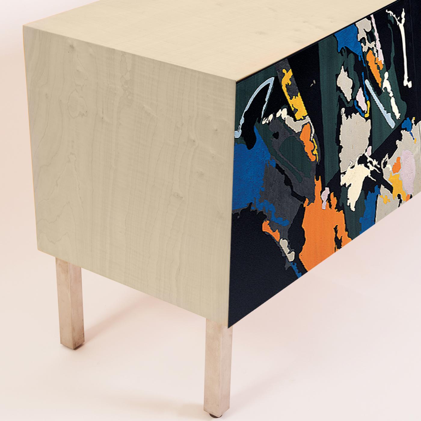 Storage transformed in art. This sideboard designed by Edoardo Franceschini and handcrafted by the skilled carpenters of Laura Meroni betrays a singularly post-modern flair. Crafted using poplar and maple wood veneer, the cabinet opens to reveal