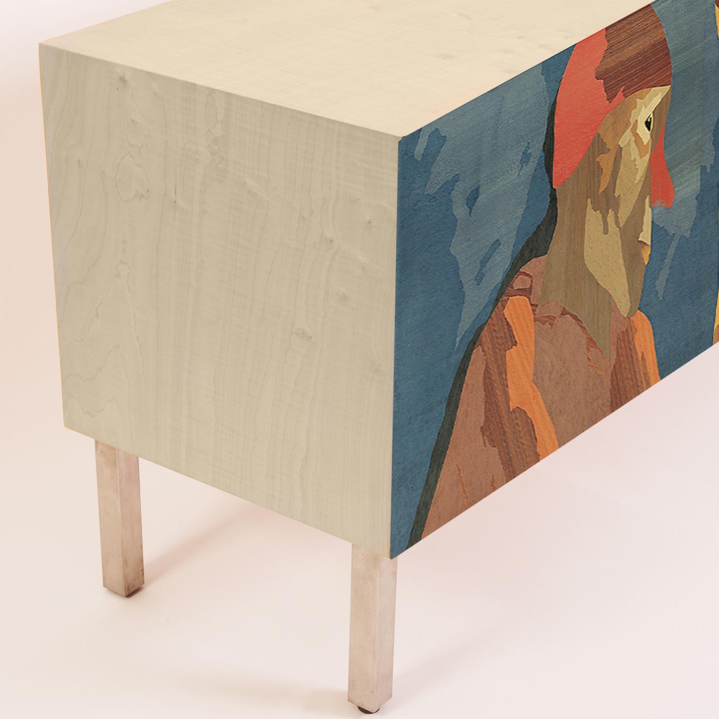 A dream-like composition designed by eminent Milanese poet and artist Emilio Tadini transforms this sideboard into veritable art. The cabinet features a multi-ply poplar wood structure covered in natural maple wood veneer. When open the sideboard