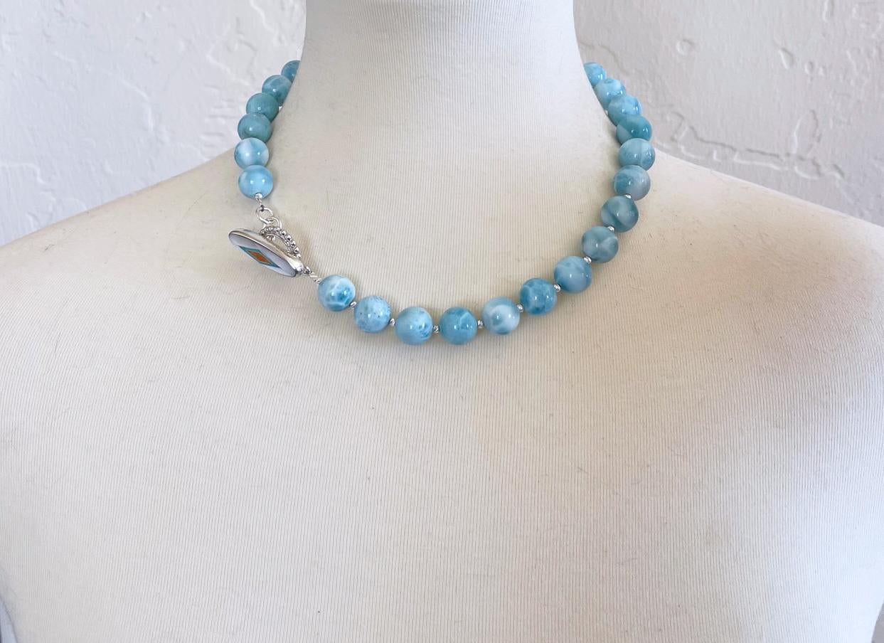 Gorgeous natural larimar bead necklace comprised of 12-13mm round larimar beads, tiny sterling silver accent beads and finished with an elegant handmade toggle clasp inlaid with Sleeping Beauty turquoise, mother of pearl, and spiny oyster.