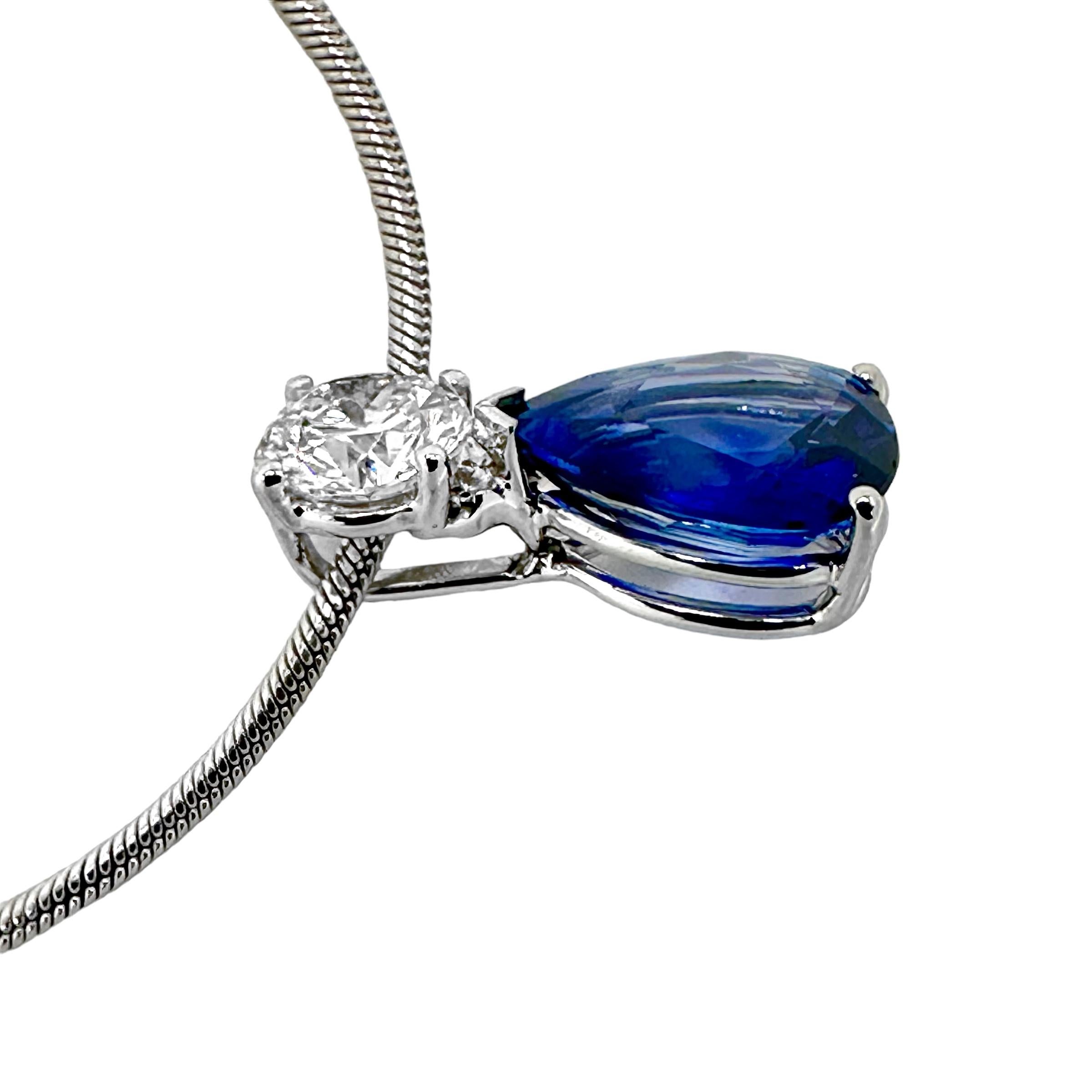 A traditional design with a modern update.
The .58ct round  brilliant cut diamond set in a 4 prong 14k white gold head, sits atop a vivid, marine blue 2.15ct pear shaped sapphire. The clean look is strong enough to stand alone, or ideal to stack