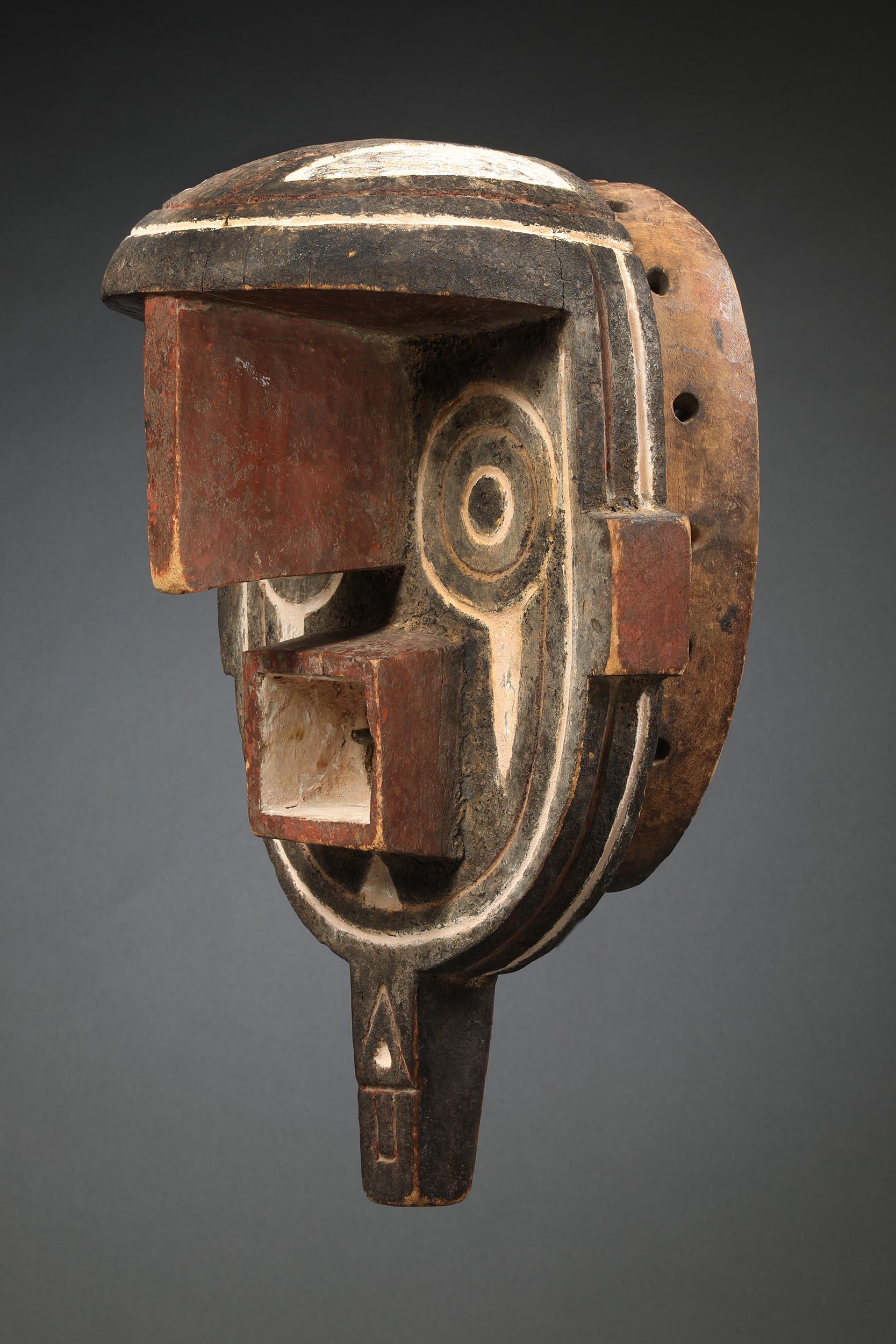 Bwa mask with large geometric eyes and flat face with projecting nose. Intense expression conveying force and power. Classic Mossi scarification marks around face. Patina of age and use. Wood with pigments, created in the early 20th century.