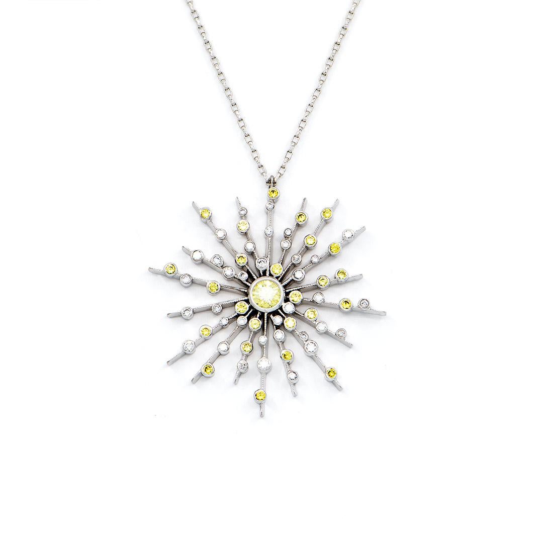 Part of the 'Soleil' collection by Natalie Barney, this pendant necklace features a 0.37 carat VS1 round Intense Fancy Yellow Diamond in its centre, 26 Yellow Sapphires with a total weight of 0.58 carats and 31 Diamonds with a total weight of 0.43
