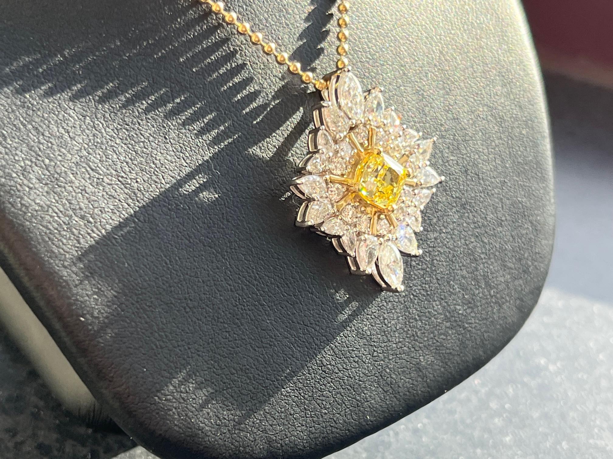 Beautiful Star-shaped pendant necklace.  1.31 Fancy intense yellow (GIA Certificate #2367295053), VS1 quality with 2.19 white diamonds set in 18K Yellow and white gold.  18in chain (14K yellow gold) 