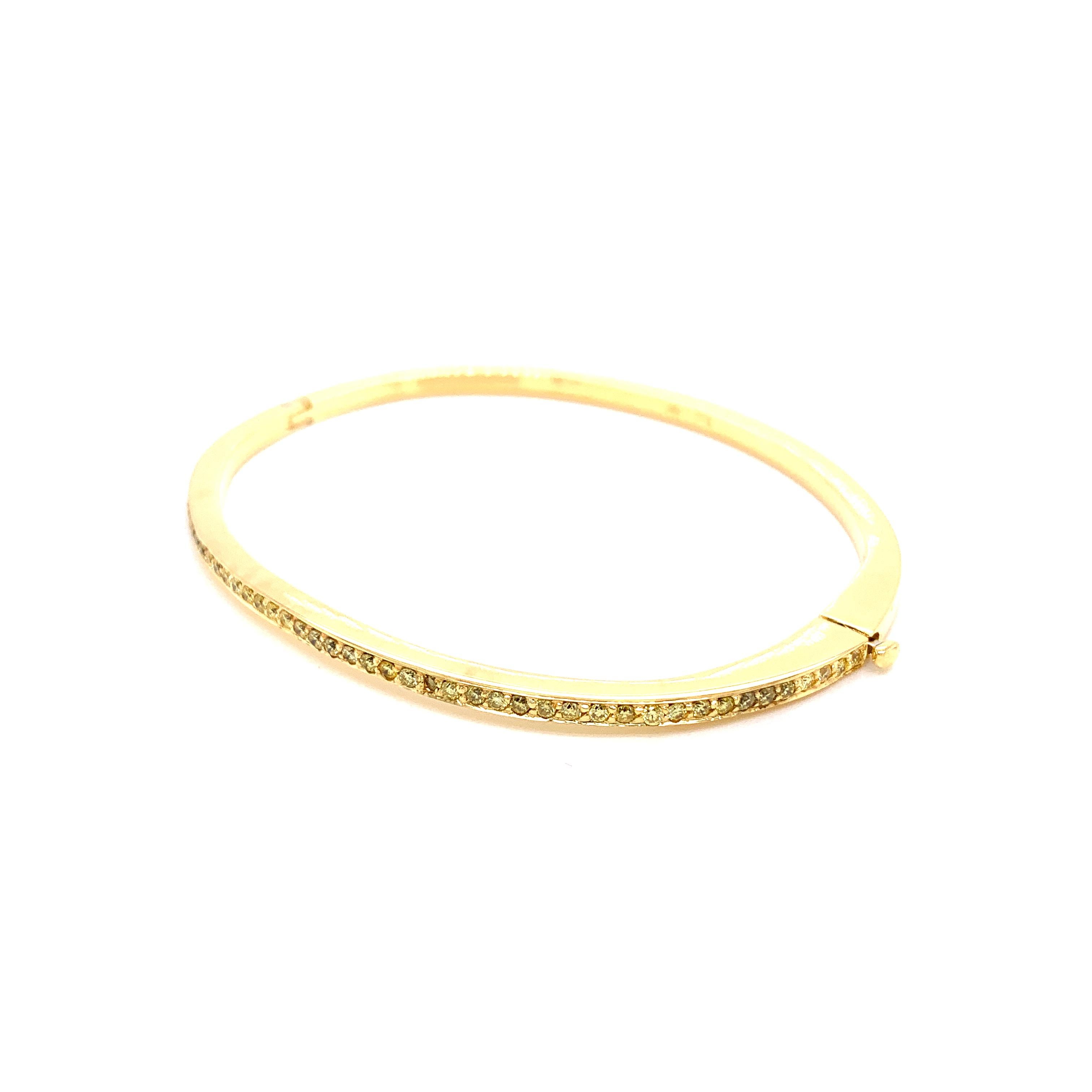 Intense Yellow Round Diamonds and 18K Yellow Gold Bangle:

An elegant bangle, it features beautiful intense yellow round brilliant diamonds weighing 0.80 carat. The diamonds are of fine quality and clarity, with good brilliance and lustre. The