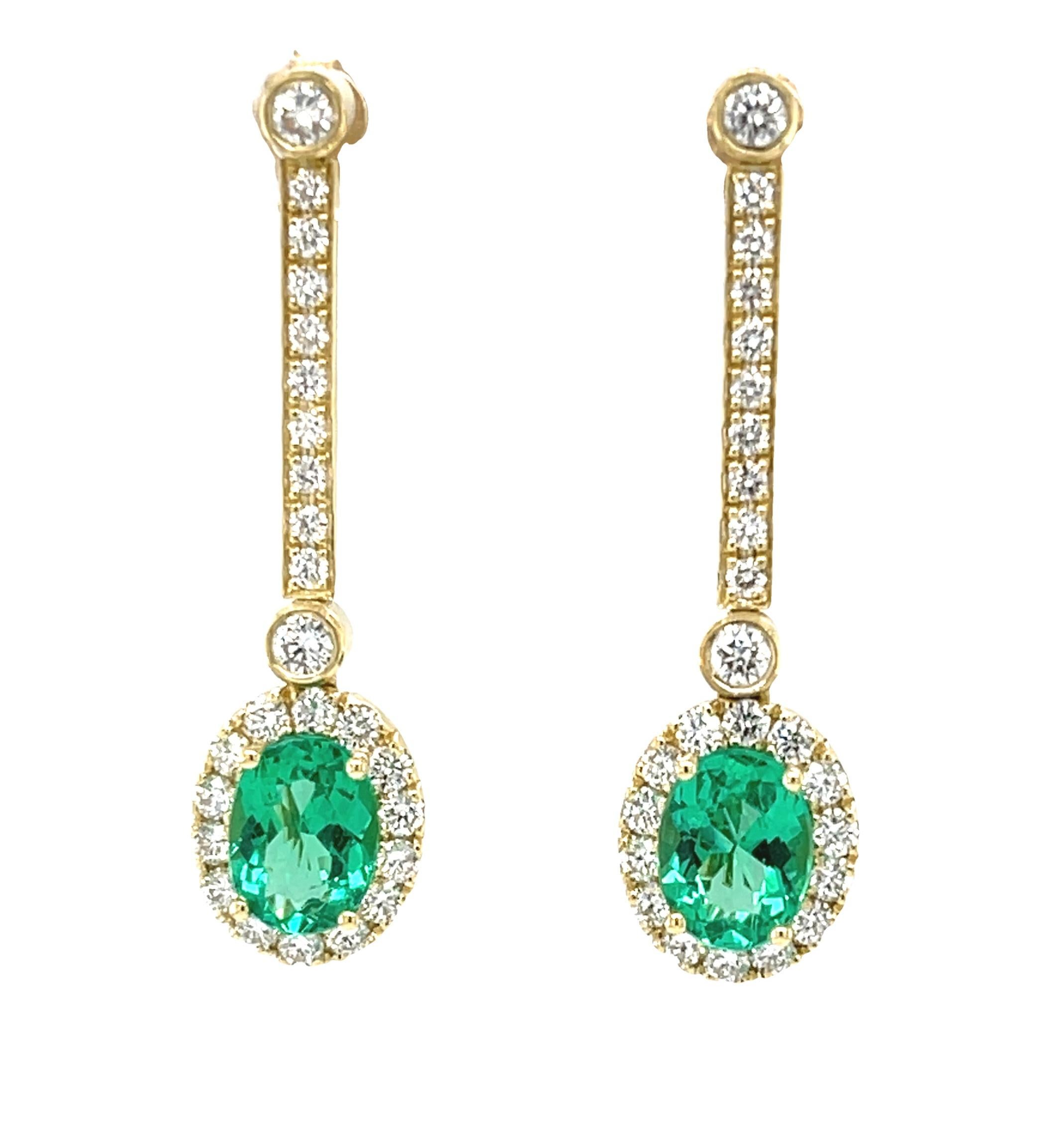 These sophisticated and beautifully versatile earrings feature emerald and diamond drops suspended from an elegant line of sparkling diamonds! The perfectly matched oval emeralds are fine quality with exceptional clarity and gorgeous, bright green