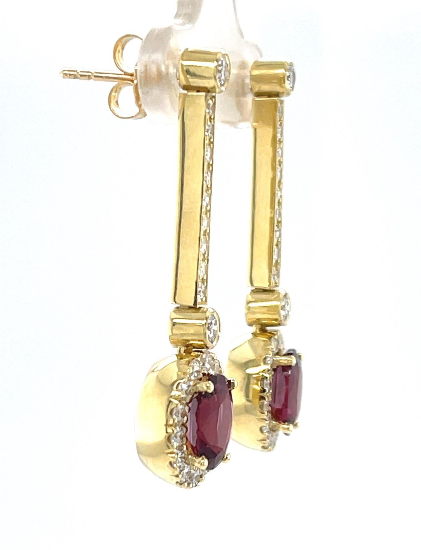 
These sophisticated and beautifully versatile earrings feature ruby and diamond drops suspended from an elegant line of sparkling diamonds! The perfectly matched oval rubies are fine quality with exceptional, bright red color. Set in 18k yellow
