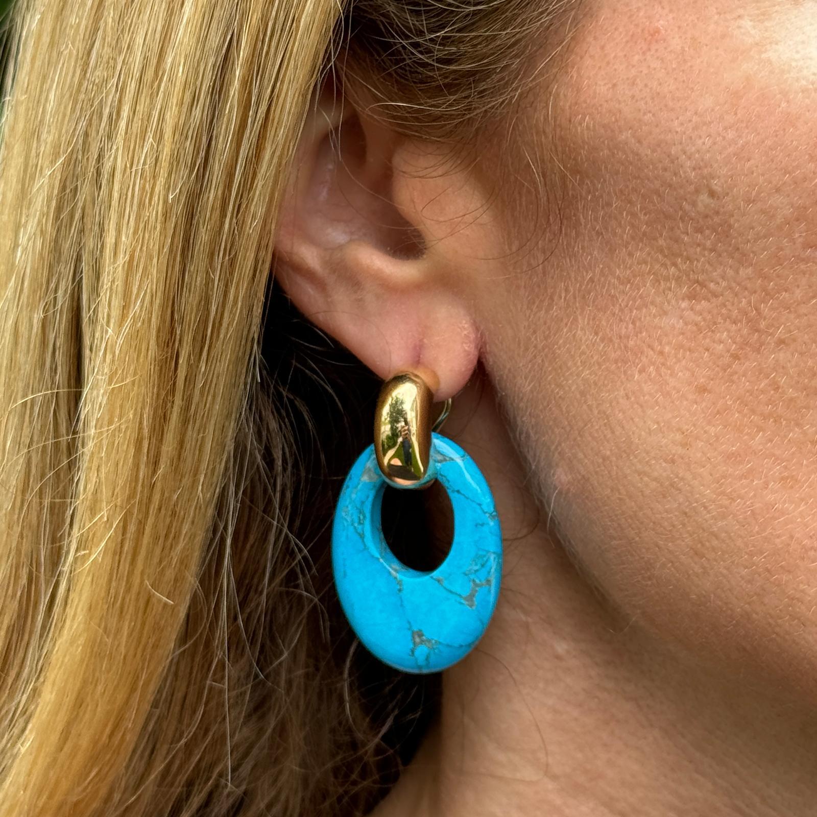 Interchangeable turquoise, onyx, and tiger's eye gemstone drop door knocker earrings crafted in 14 karat yellow gold. The yellow gold huggie hoops can be worn alone or with the gemstone drops. The earrings measure 1.50 inches in length with