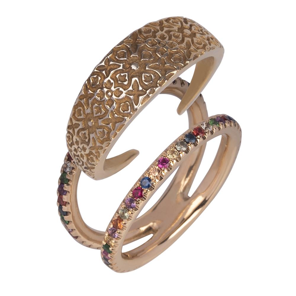This ring looks like the ultimate ring stack. It's a 14k yellow gold interchangeable ring sprinkled with a rainbow of sapphires and tsavorites. The centre wedge is carved with a Damask pattern. The wedge inserts into the outside ring and creates