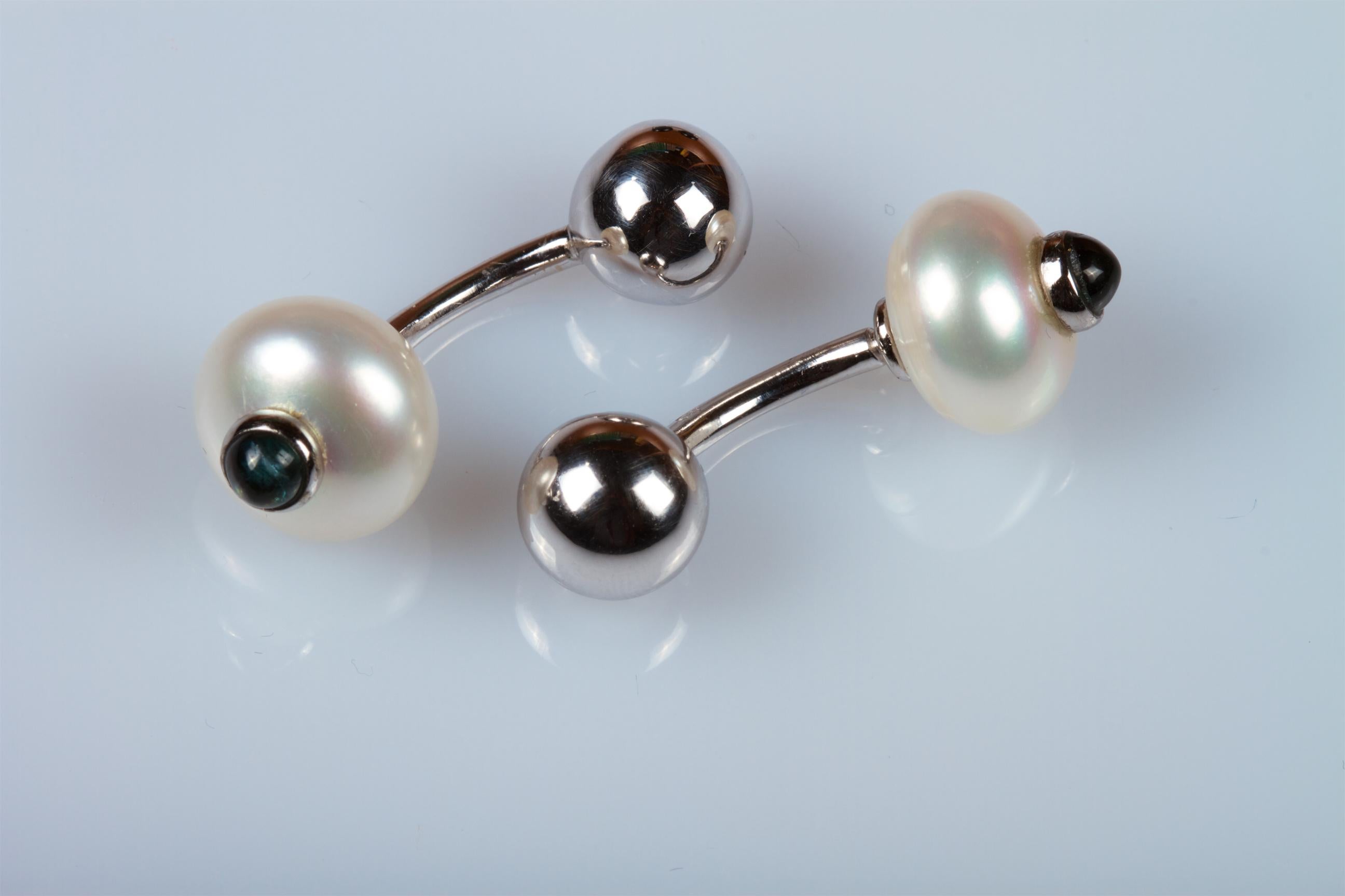 18 carat white gold cufflinks with interchangeable heads composed of:
- 2 cultured whit  pearls of a slightly flattened shape, diameter 12/13 mm, with 2 cabouchons of 0.30 carat round sapphires
- 2  onyx spheres, diameter 12.5 mm
Total weight: 10.8