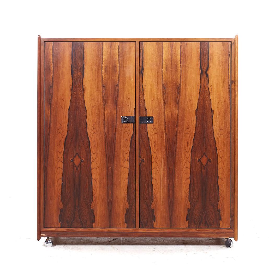 Intercontinental Design Mid Century Rosewood and Chrome Armoire Dresser

This armoire measures: 43.25 wide x 19 deep x 45.5 inches high

All pieces of furniture can be had in what we call restored vintage condition. That means the piece is restored